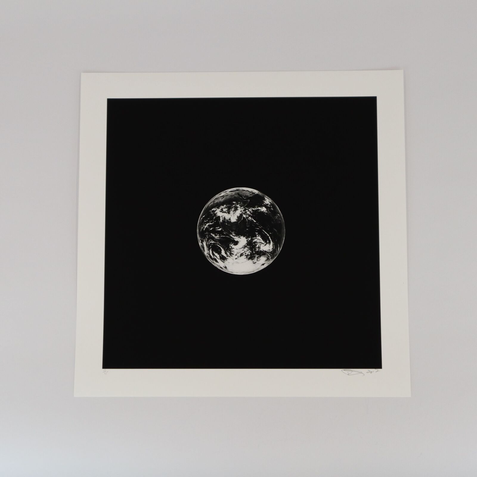 A black and white photo of the earth in the sky.