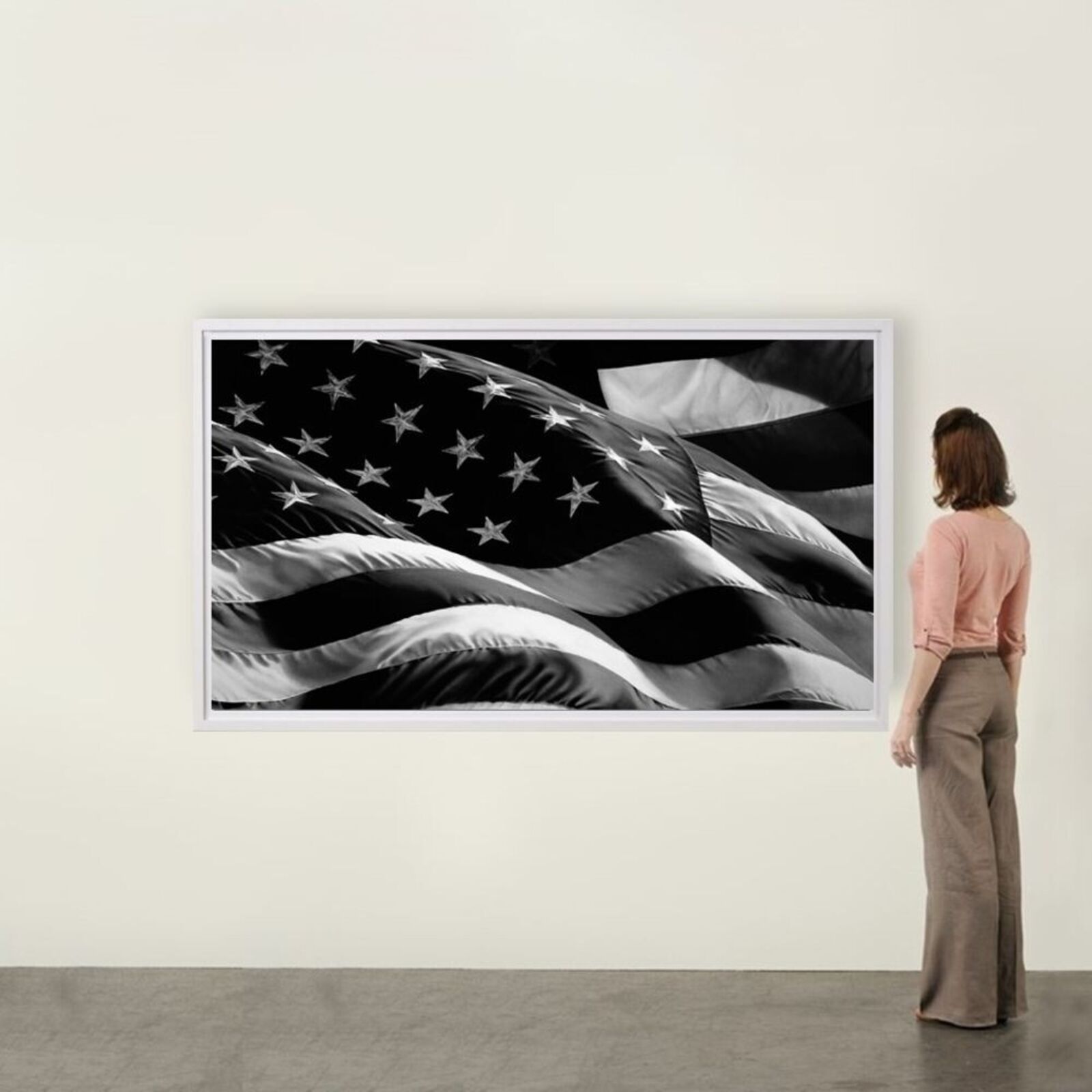 A black and white framed print of a waving flag with stars and stripes.