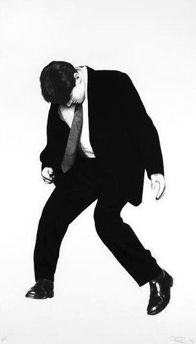 a man in a suit and tie is dancing