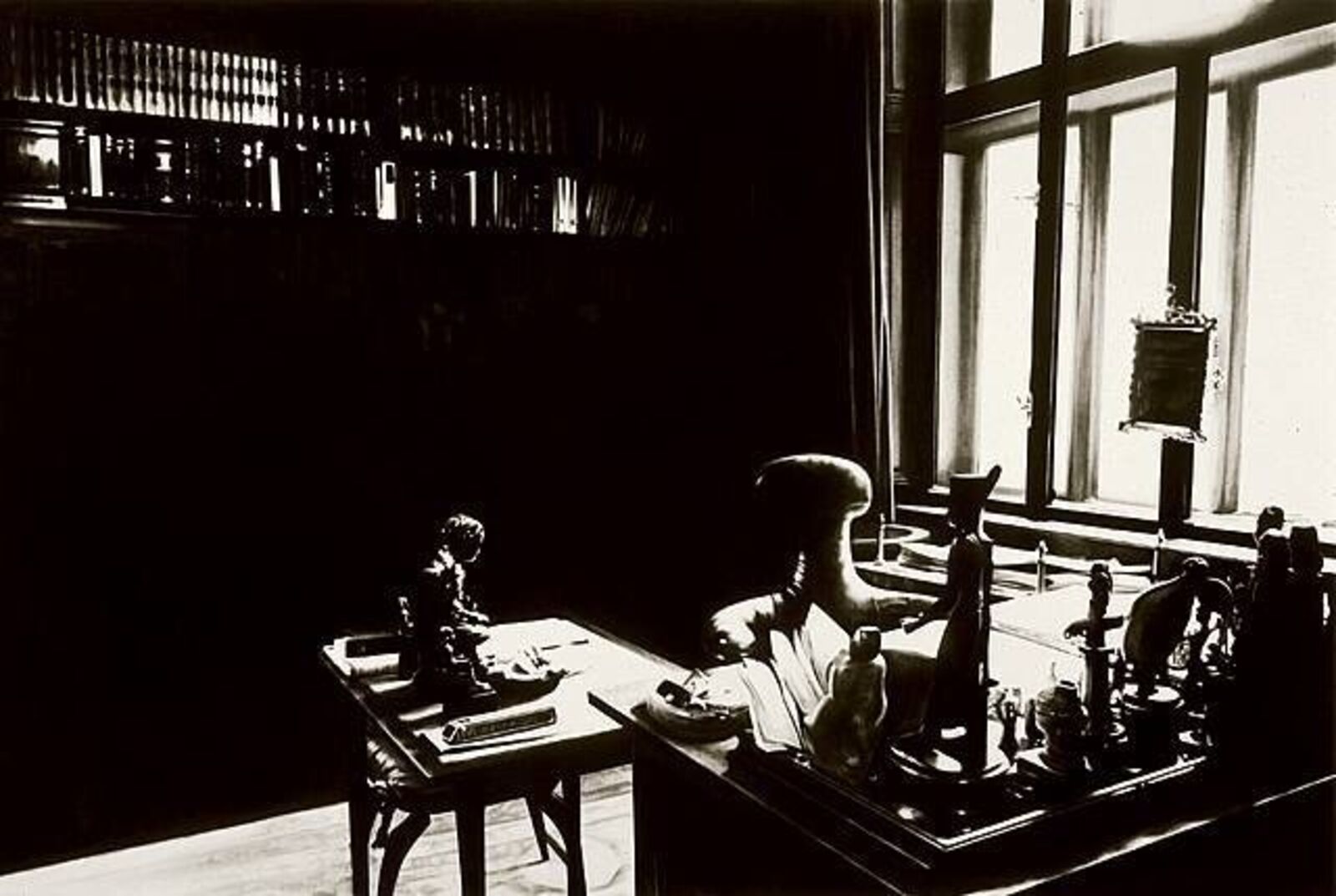 A gallery wall of black and white framed photographs showcasing interior details.