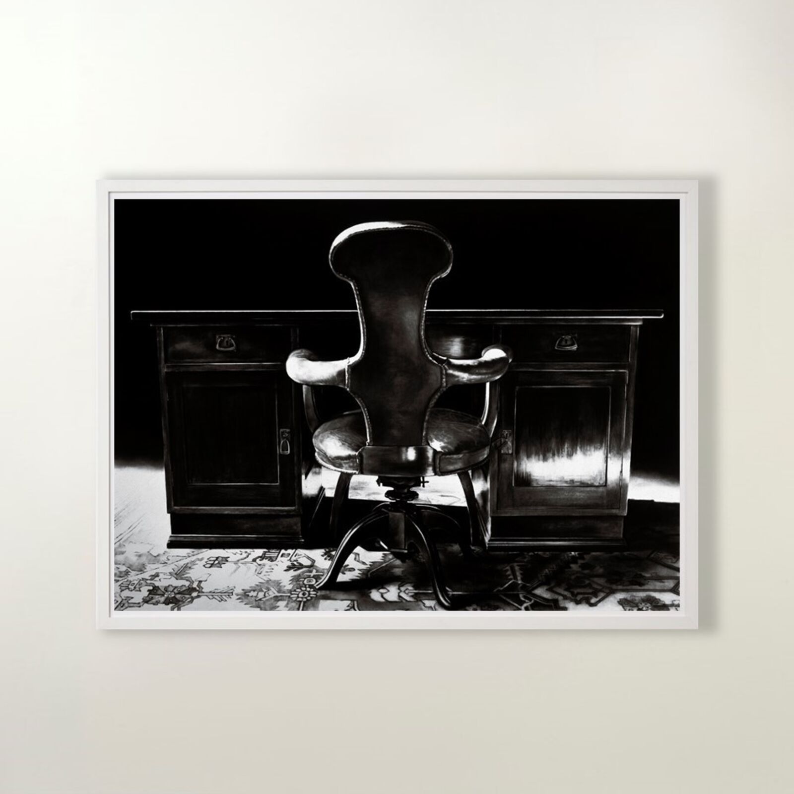 A gallery wall of black and white framed photographs showcasing interior details.