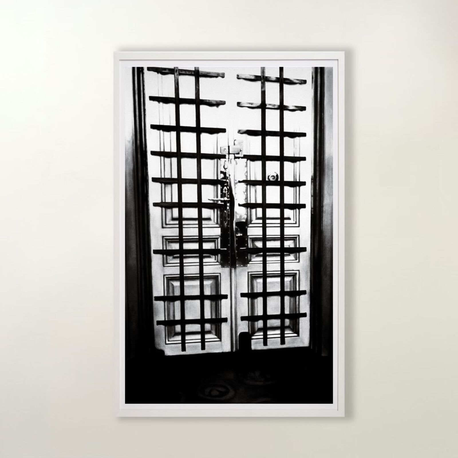 A gallery wall of black and white framed photographs showcasing interior details.
