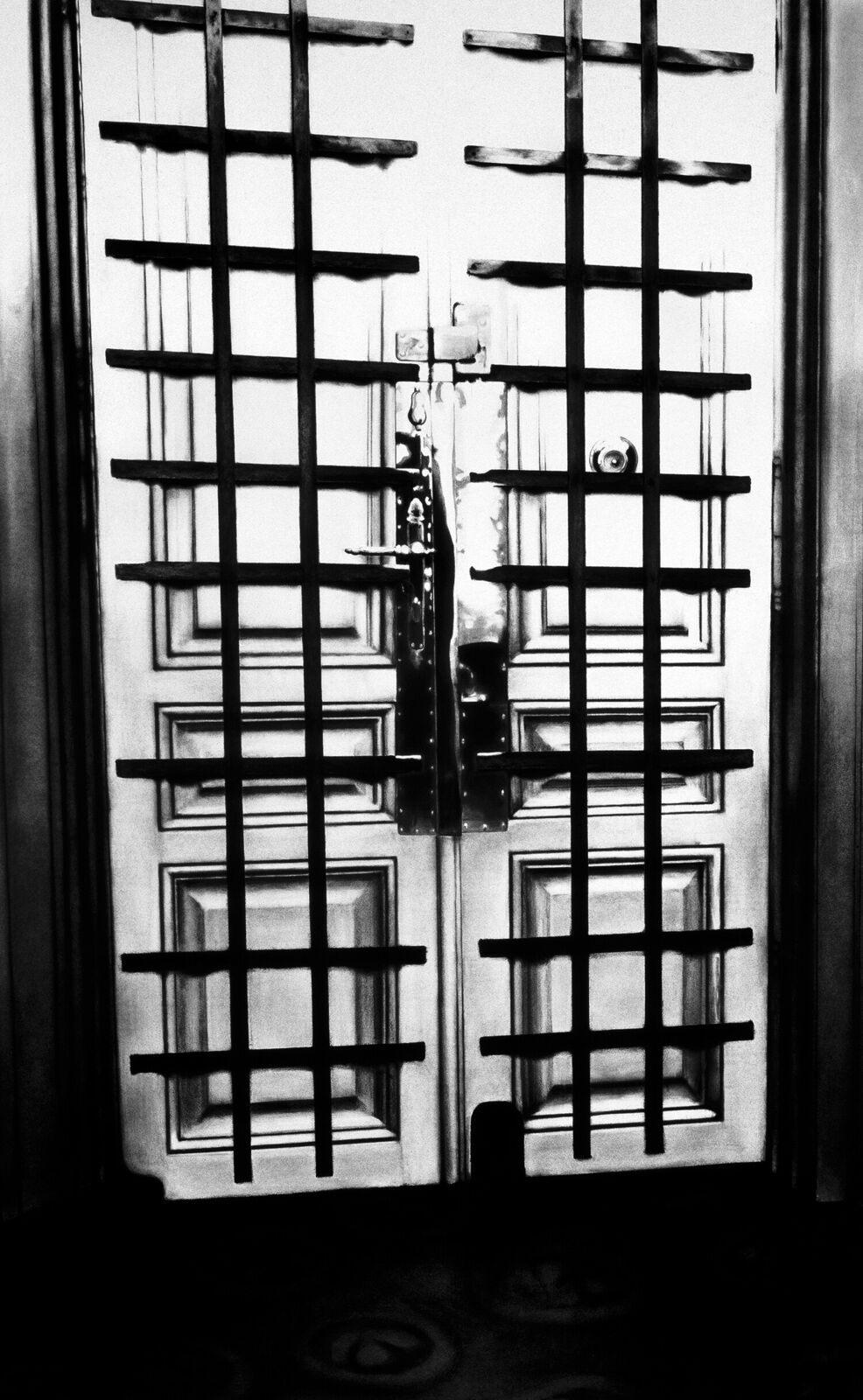 A gallery wall of black and white framed photographs showcasing interior details.