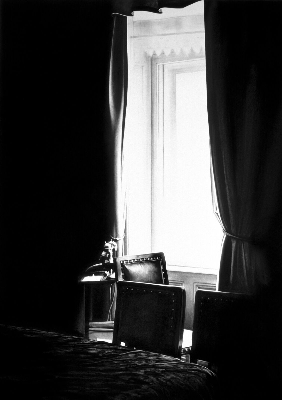 A gallery wall of black and white framed photographs showcasing interior details.