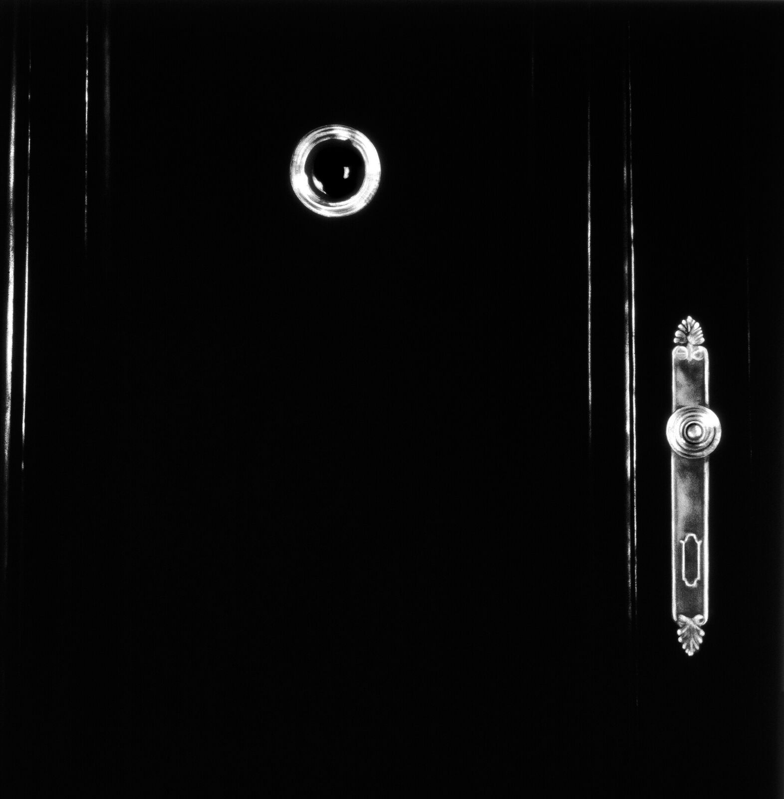 A gallery wall of black and white framed photographs showcasing interior details.