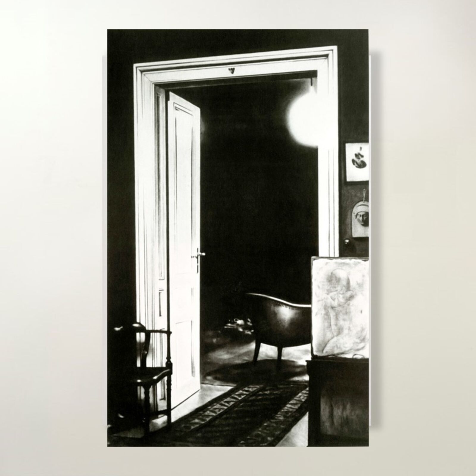 A gallery wall of black and white framed photographs showcasing interior details.
