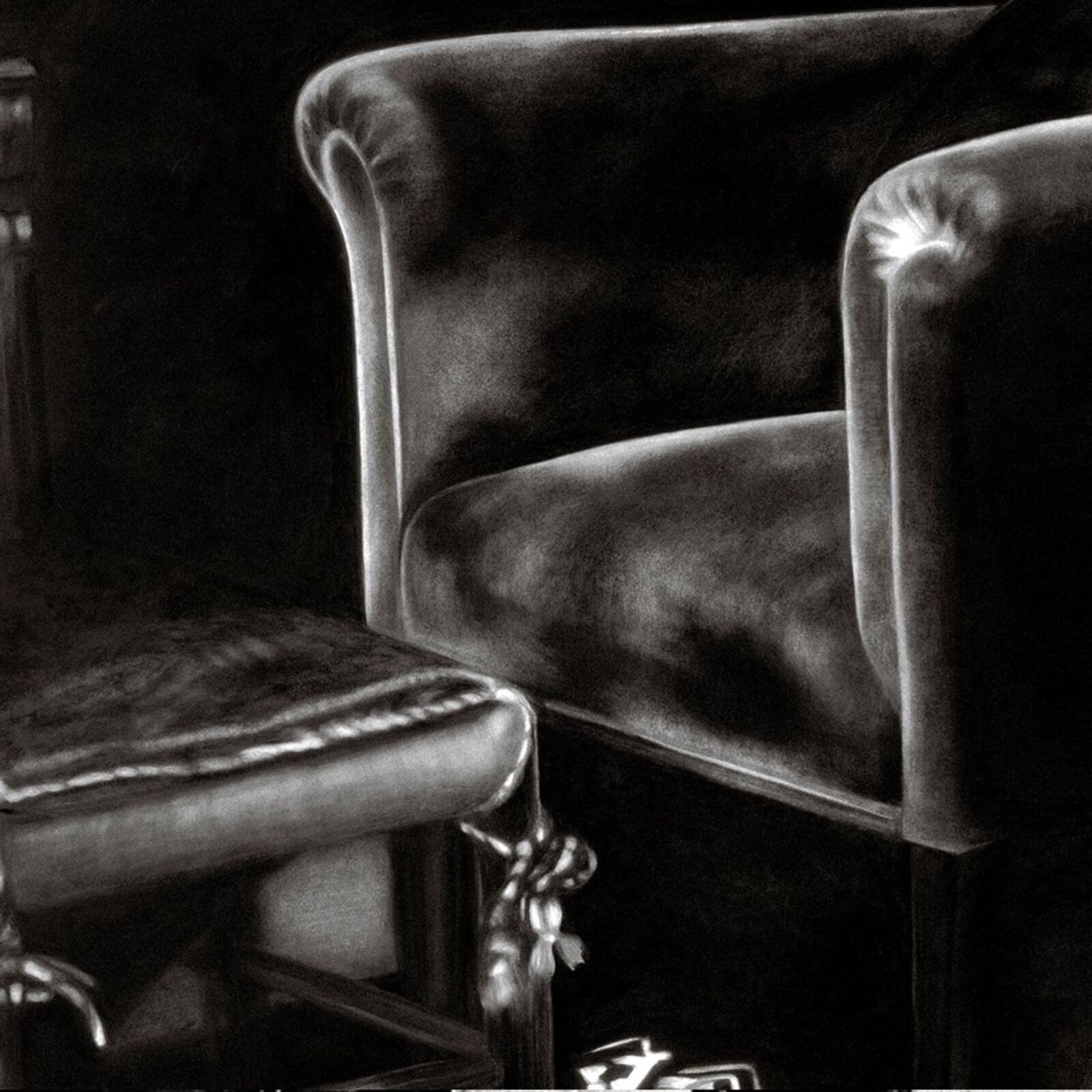 A gallery wall of black and white framed photographs showcasing interior details.