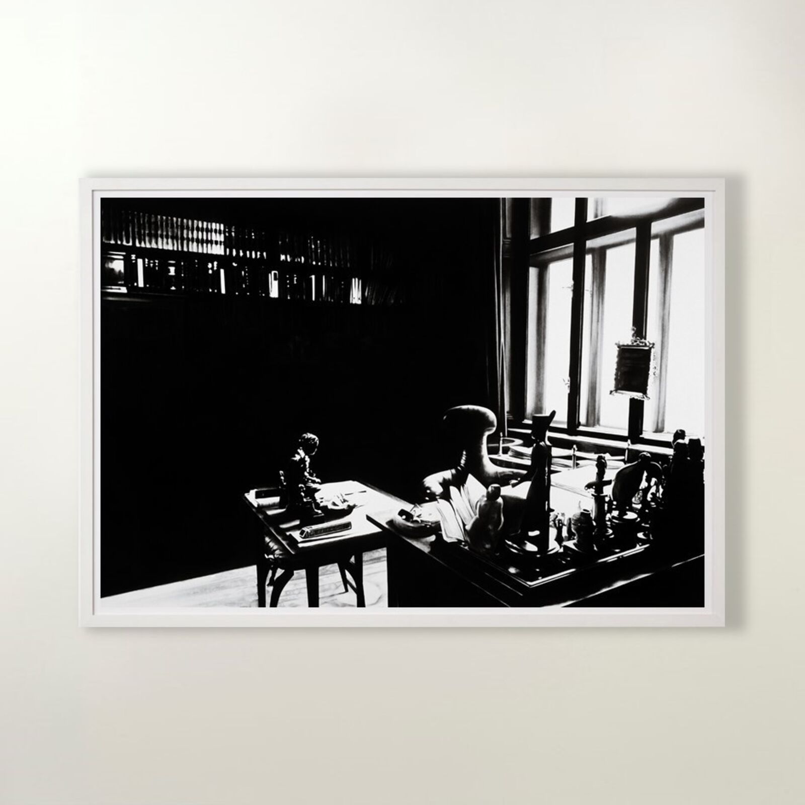 A gallery wall of black and white framed photographs showcasing interior details.