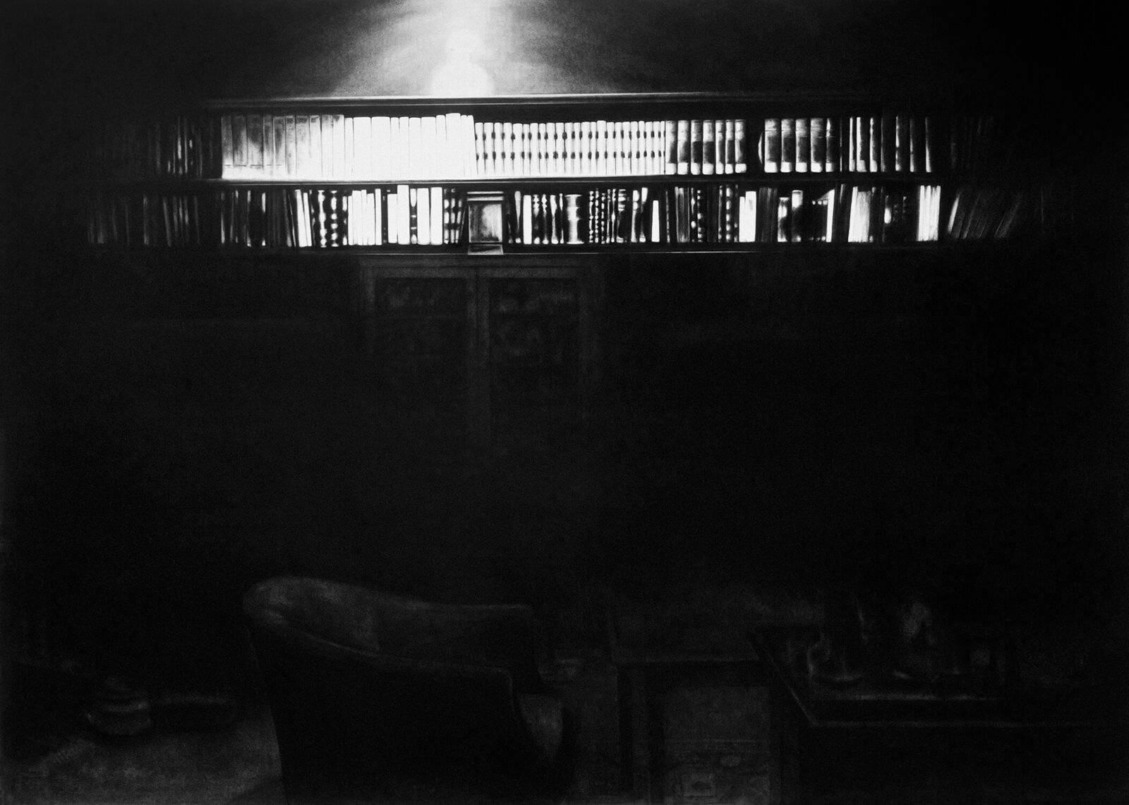 A gallery wall of black and white framed photographs showcasing interior details.