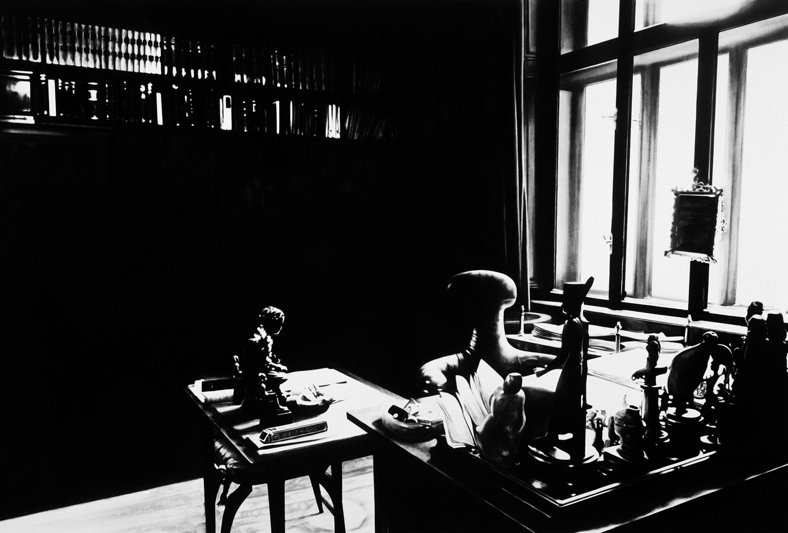 A gallery wall of black and white framed photographs showcasing interior details.