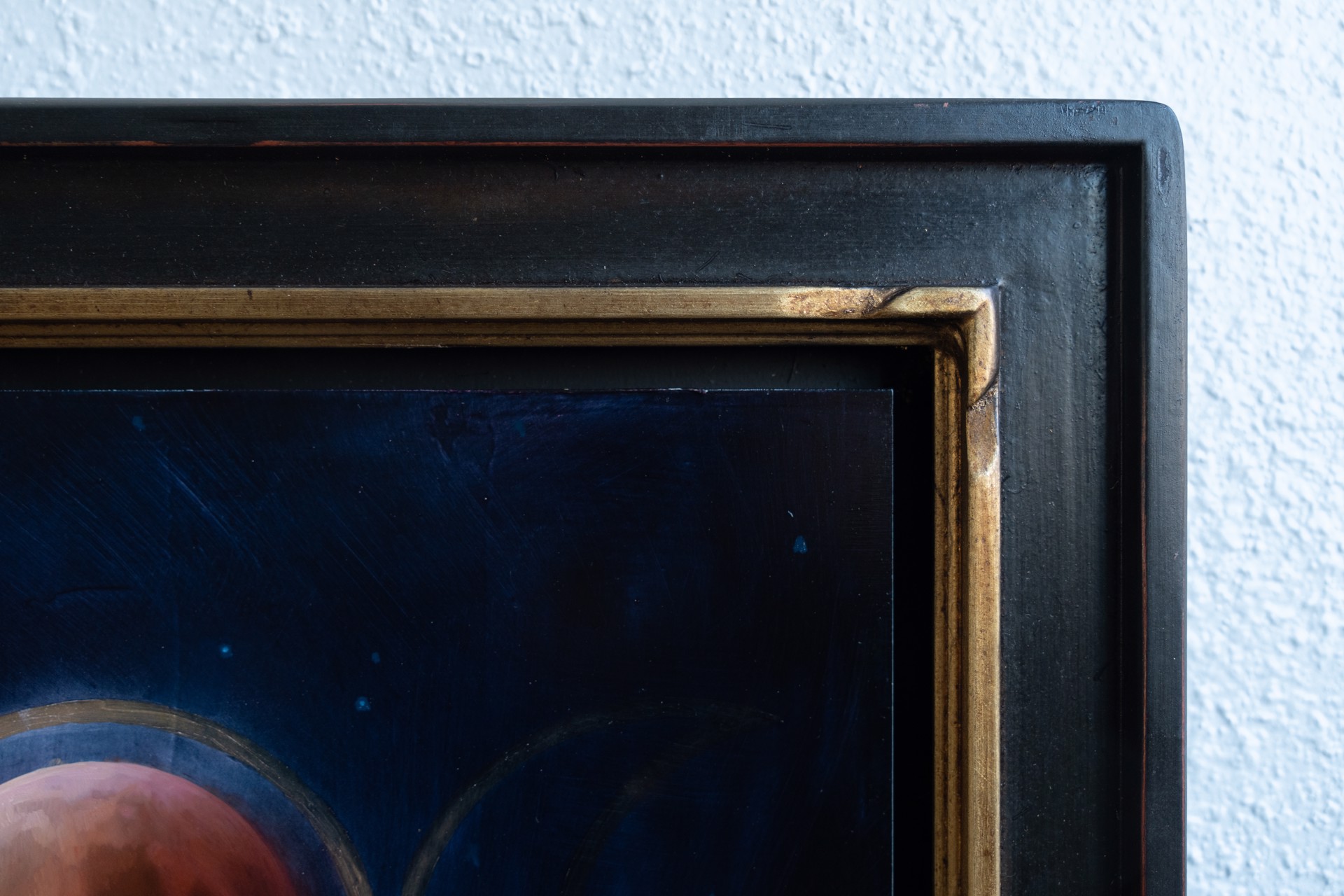 A painting of three phases of the moon in the night sky.