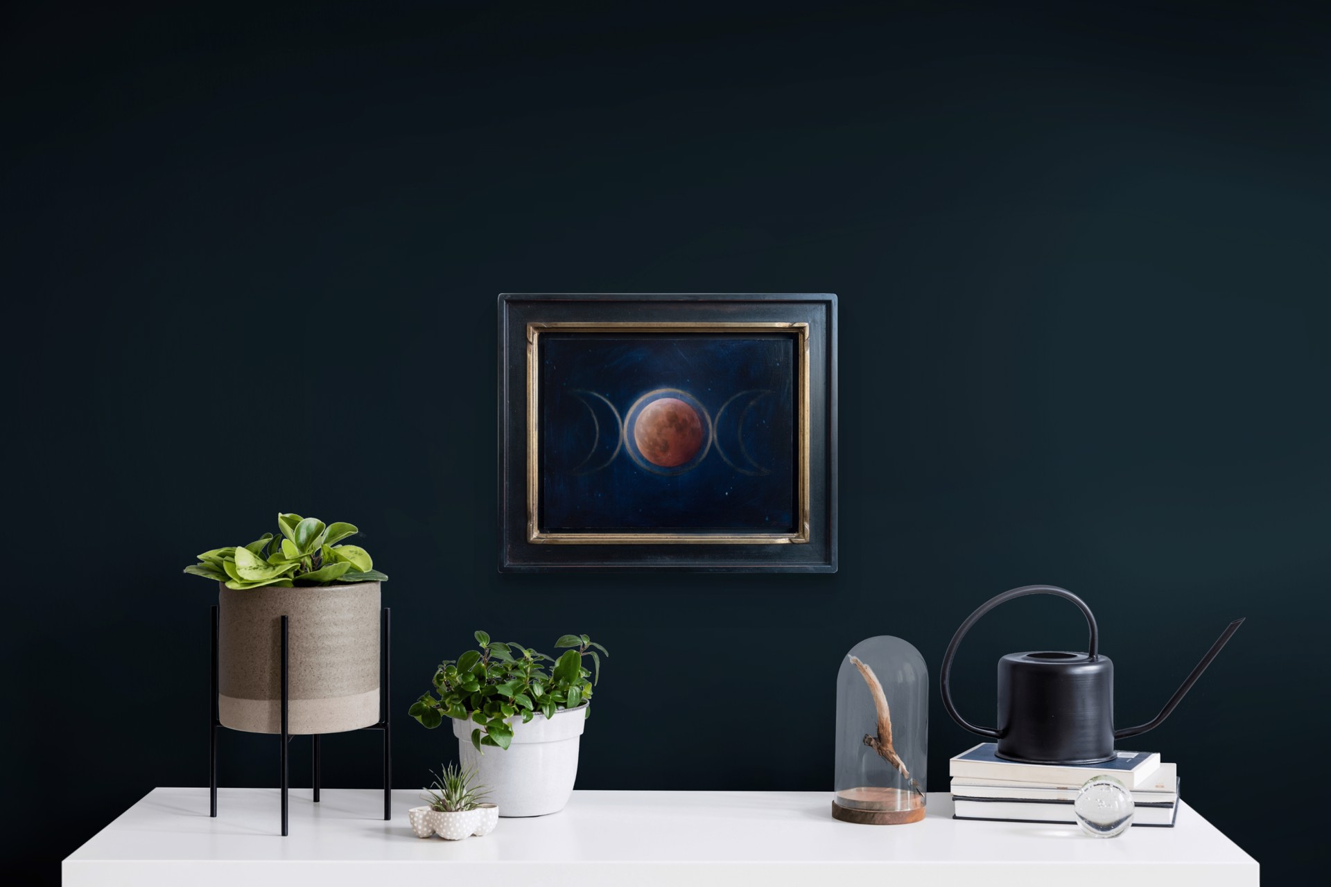 A painting of three phases of the moon in the night sky.