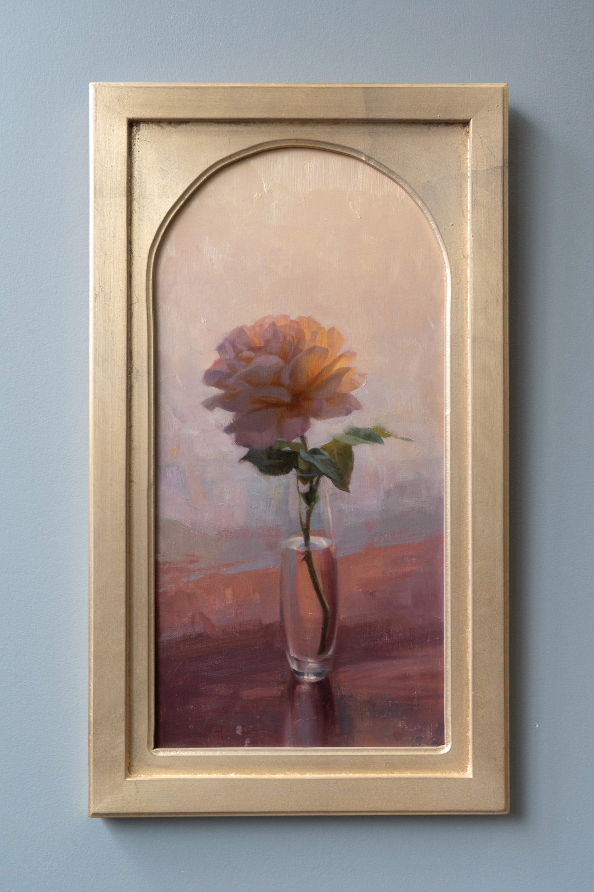 A soft, impressionistic still life of a single rose in a glass vase.