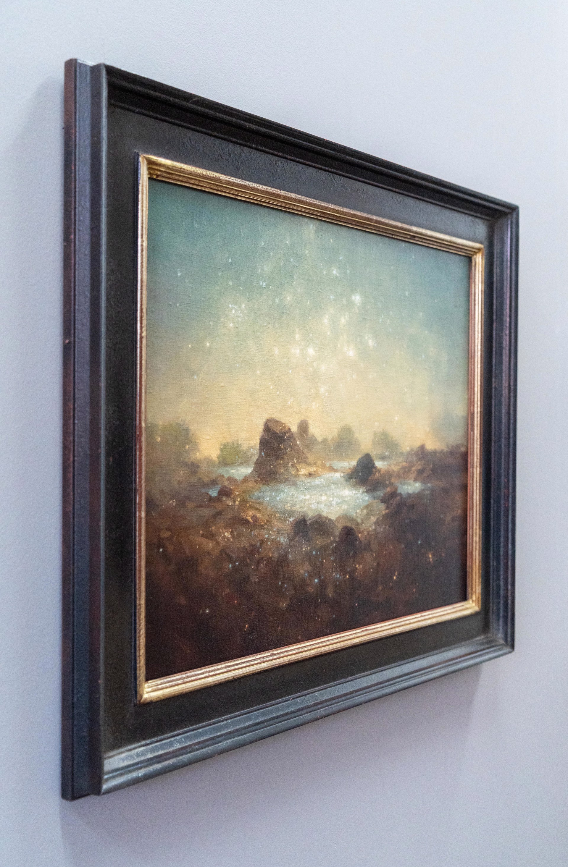 A painting of a rocky landscape with a starry sky.