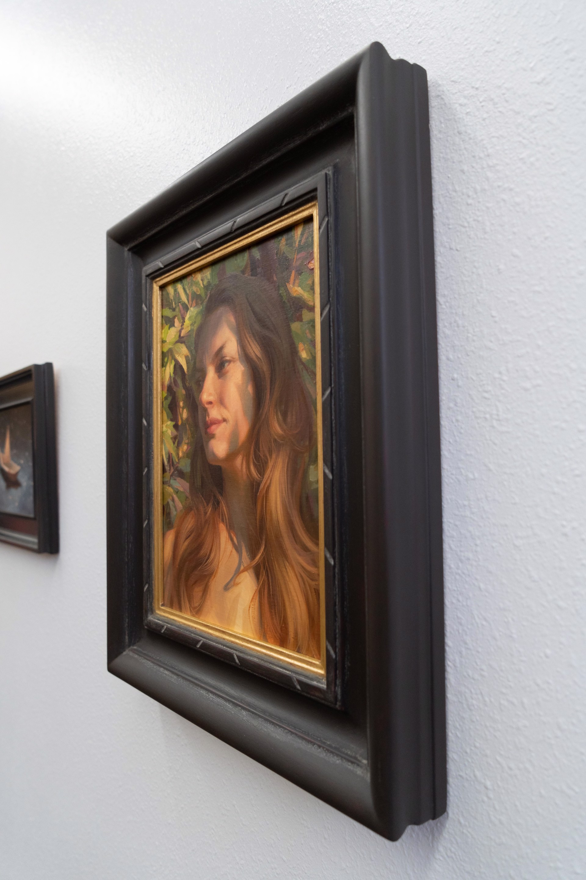A painting of a woman with long brown hair.