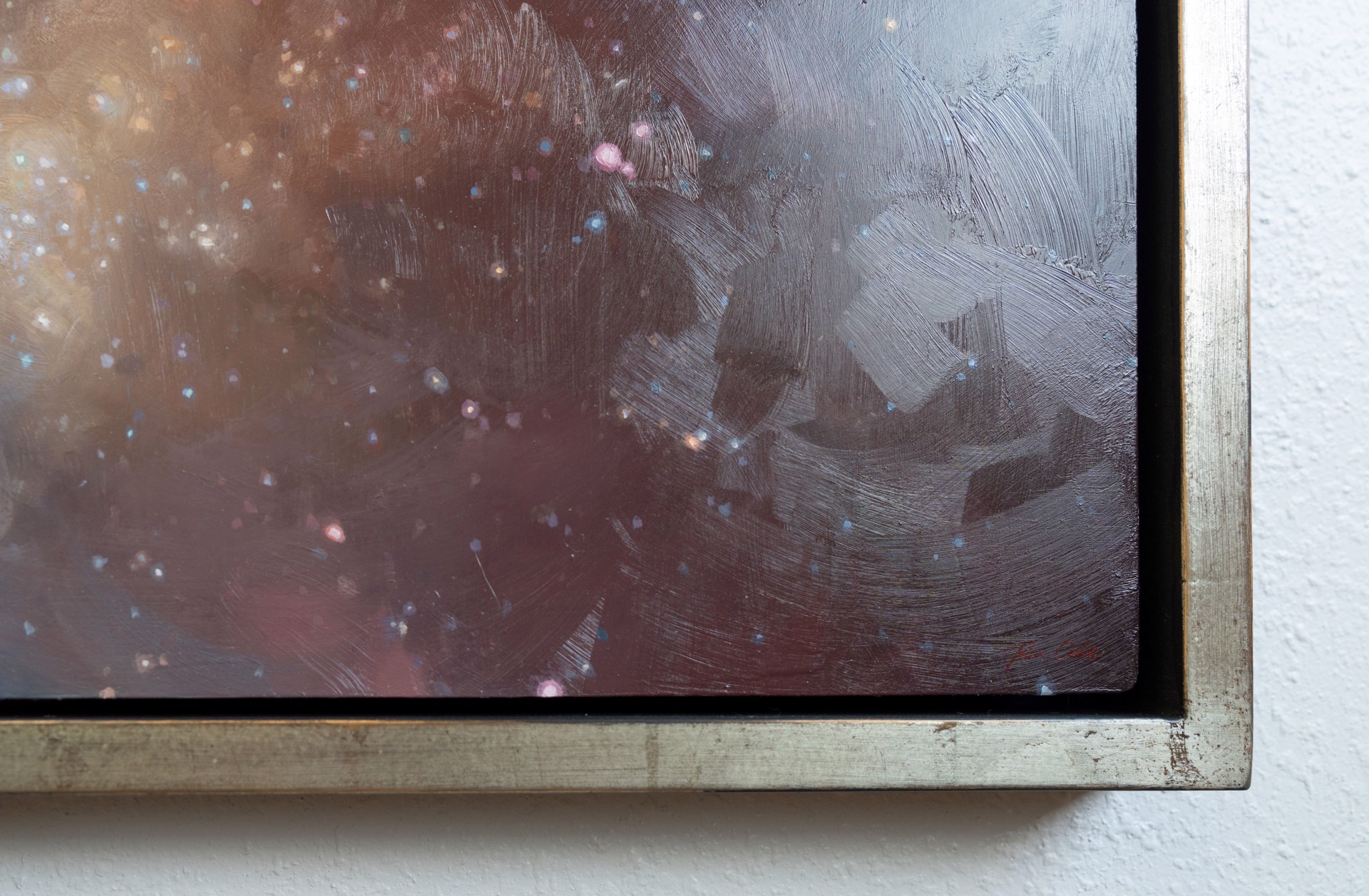 A cosmic nebula scene featuring a glowing central cloud surrounded by dark space and scattered stars.