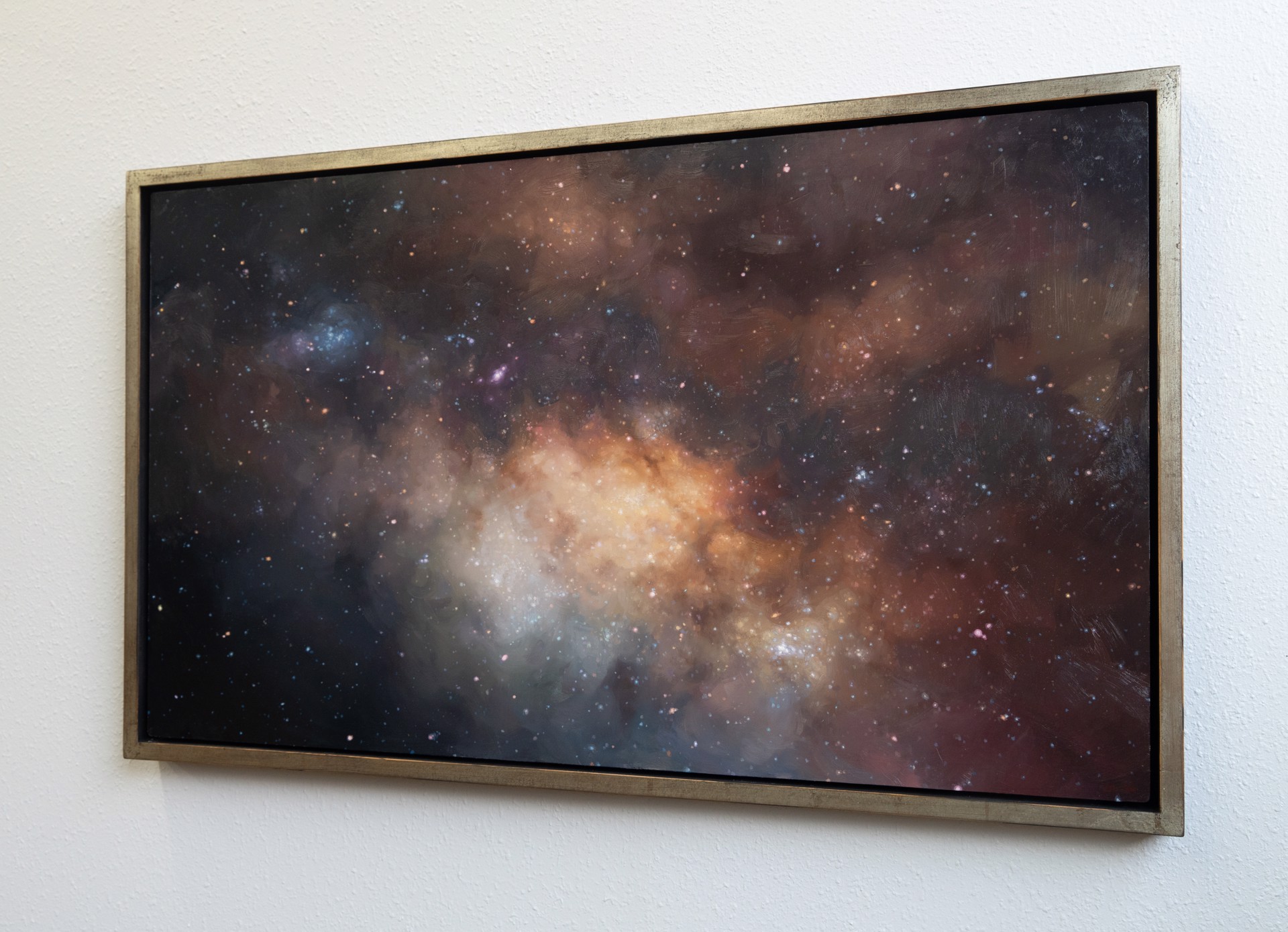 A cosmic nebula scene featuring a glowing central cloud surrounded by dark space and scattered stars.
