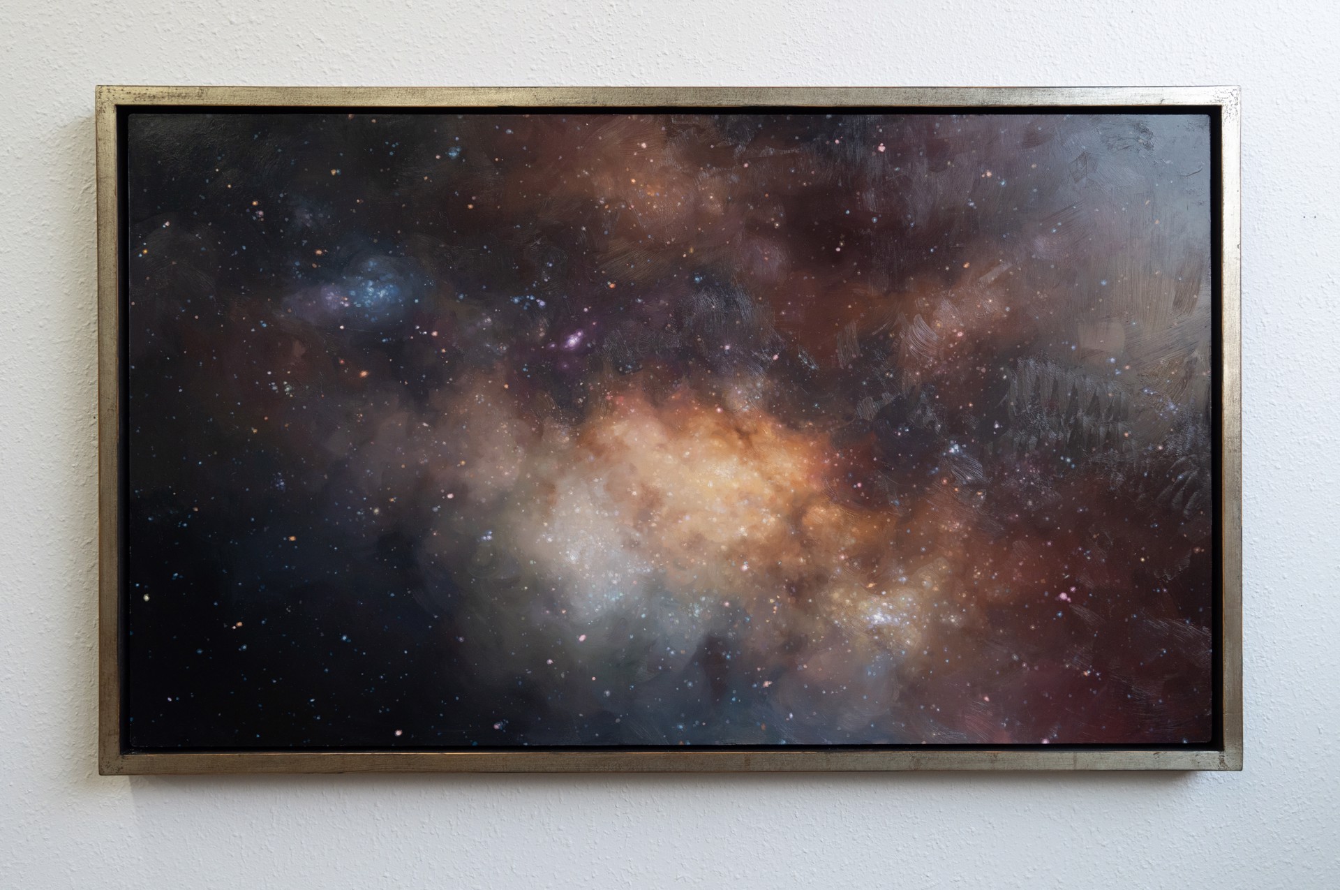 A cosmic nebula scene featuring a glowing central cloud surrounded by dark space and scattered stars.