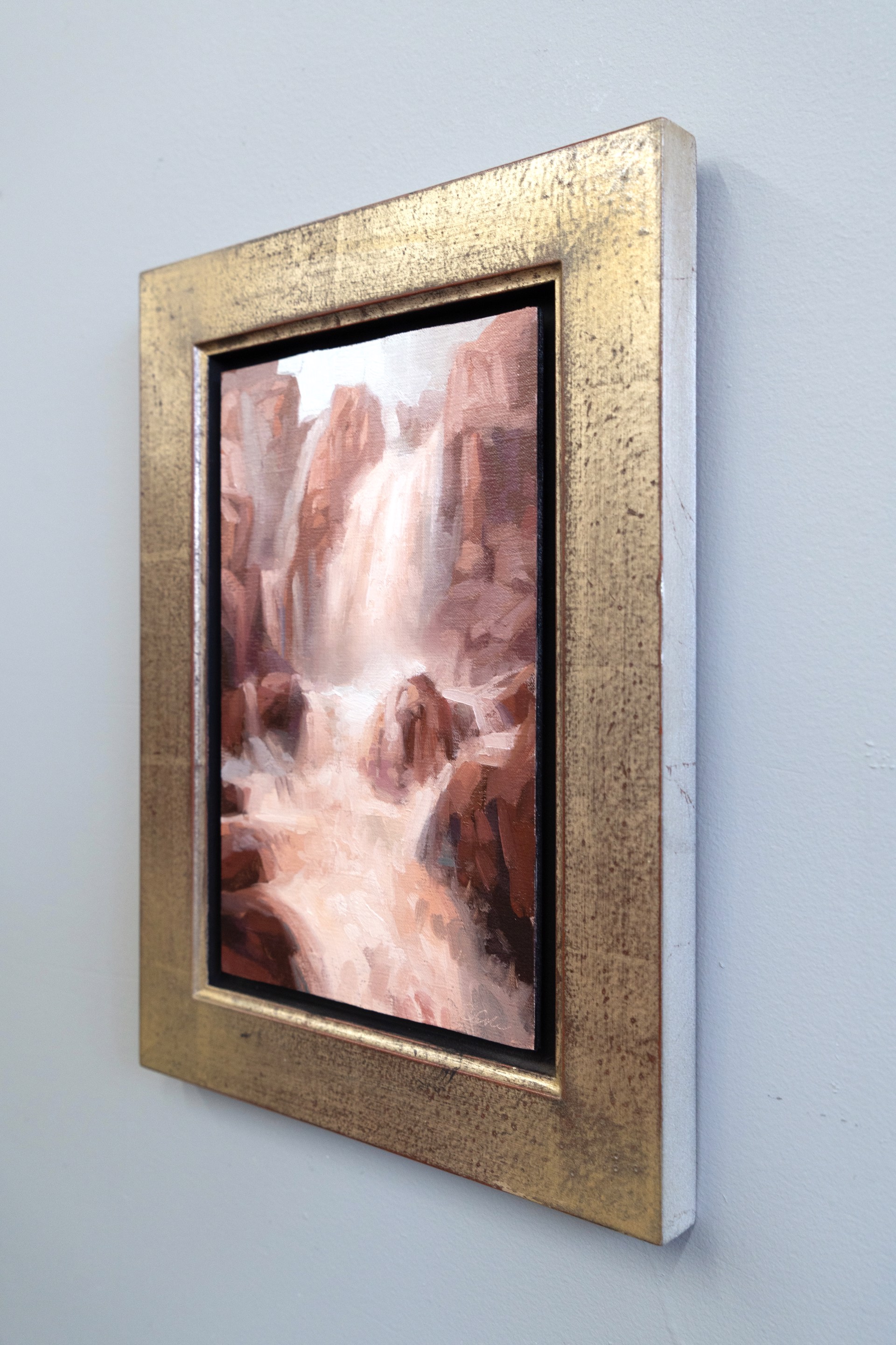 A painterly landscape of a waterfall cascading through reddish rock formations.