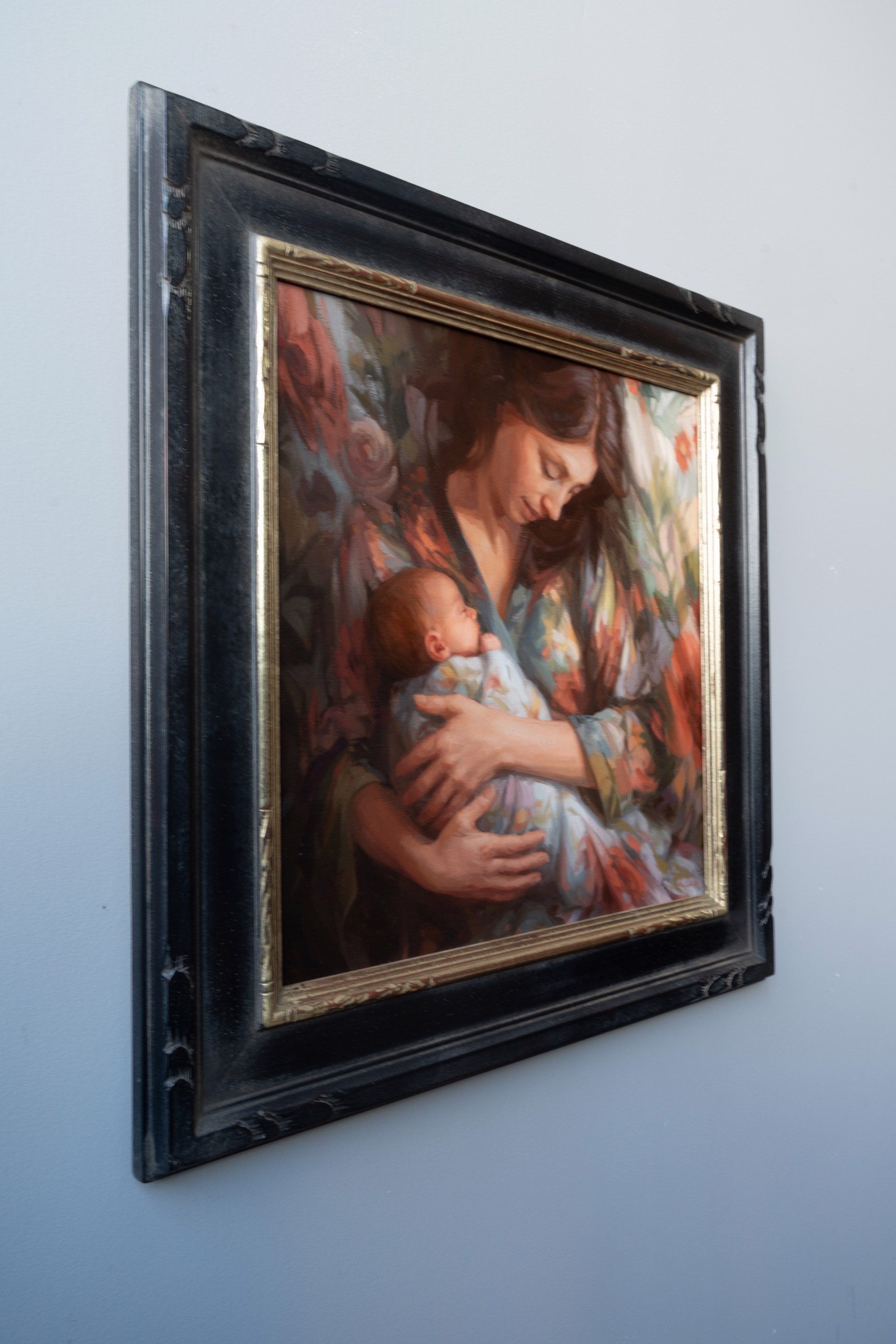A painting of a woman holding a baby in her arms.