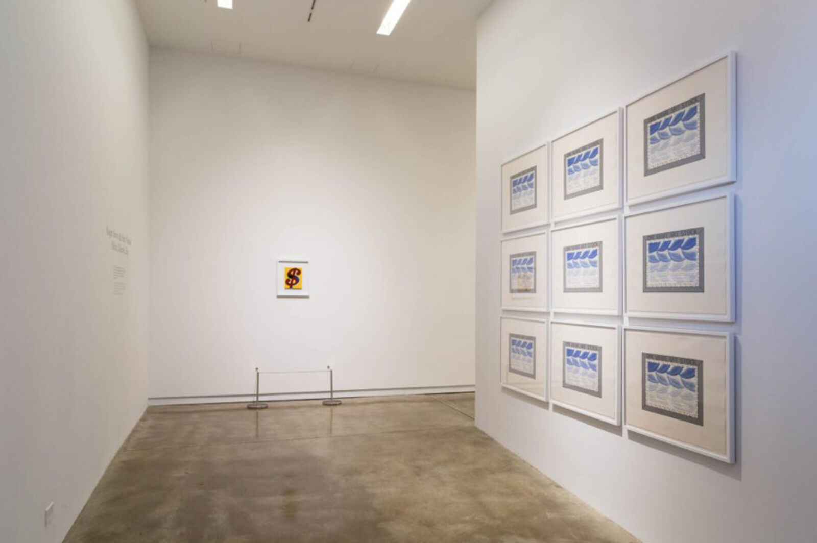 A framed one share art stock certificate on a white wall.