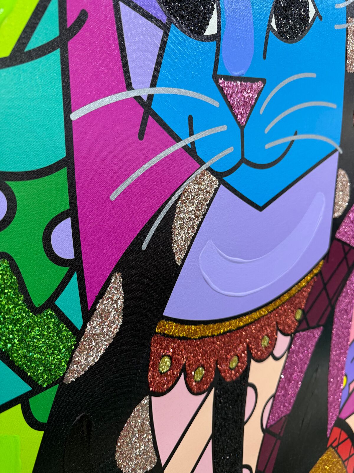 A painting of a blue cat wearing a colorful dress.