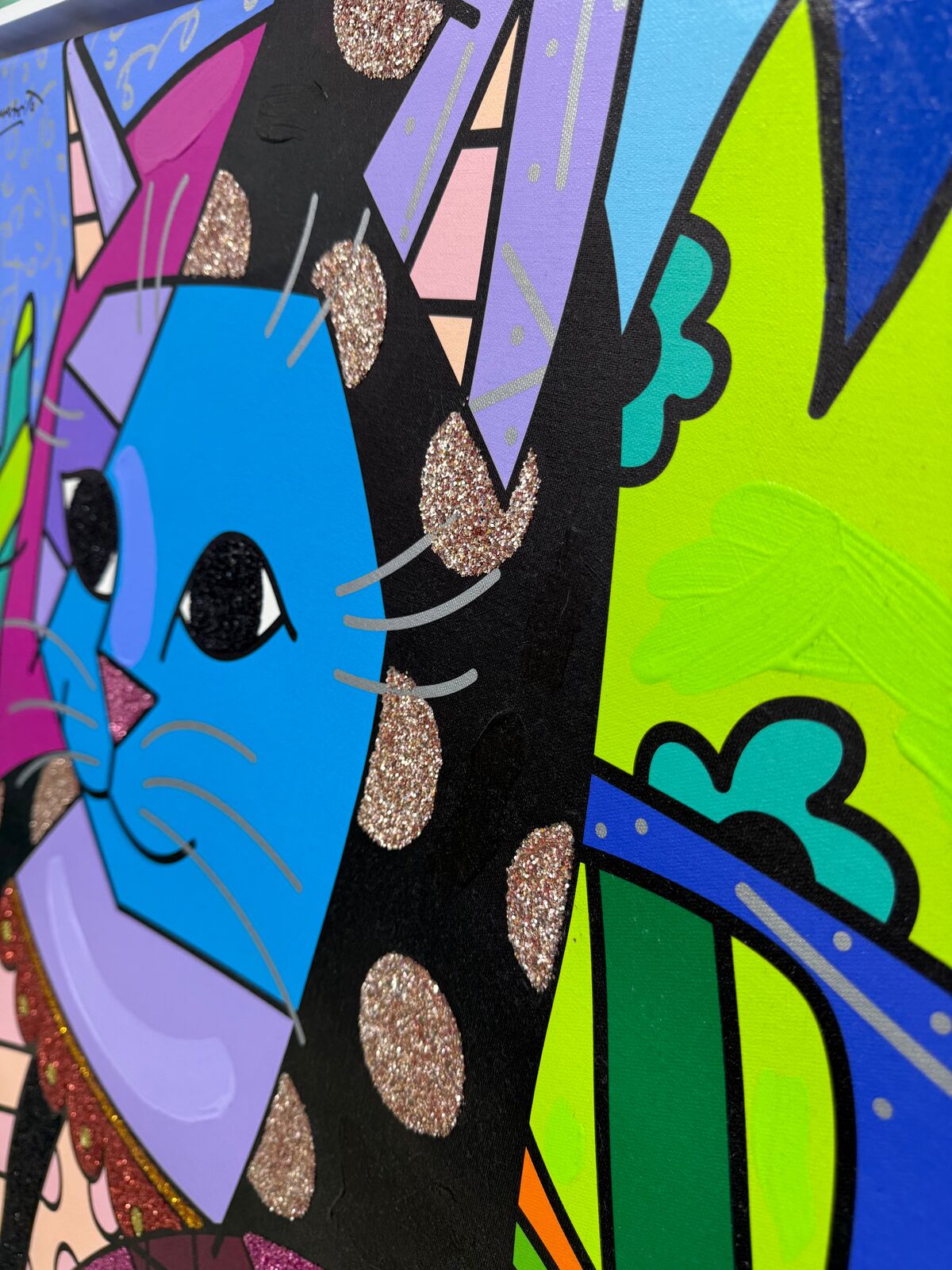 A painting of a blue cat wearing a colorful dress.
