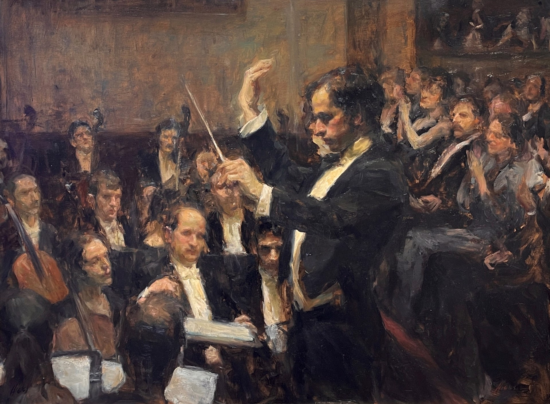 A conductor leads an orchestra in a warmly lit concert hall.