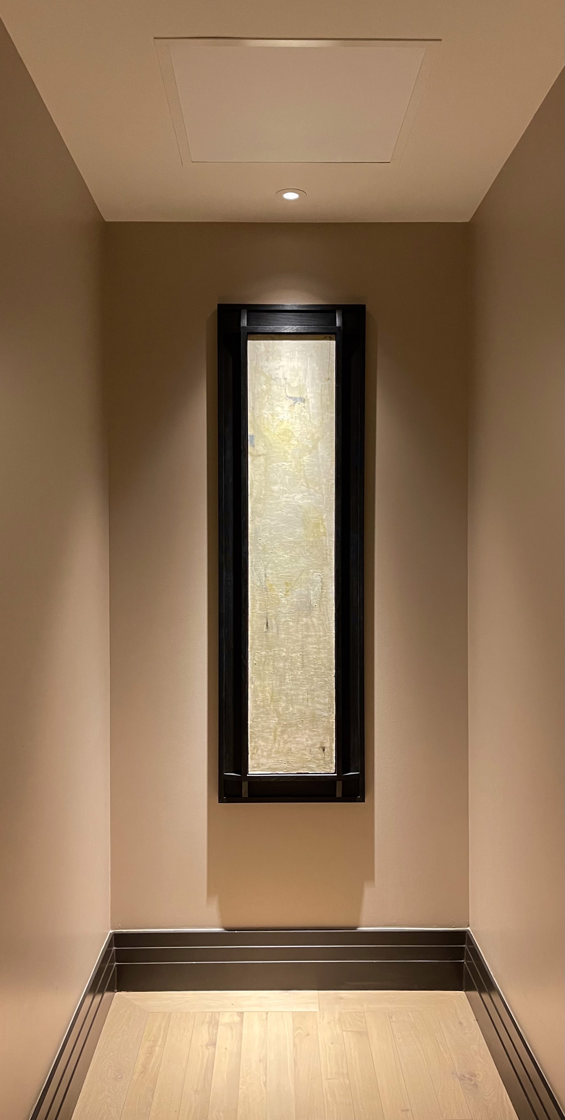 A textured abstract composition featuring a vertical wooden plank with layered paint and visible grain.