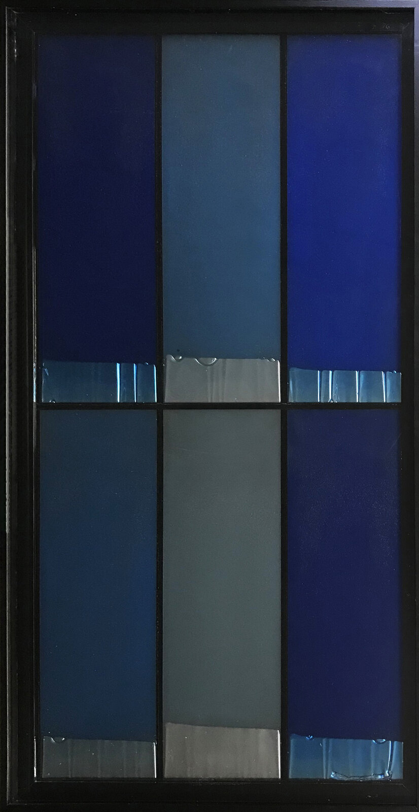A stained glass window with a blue background and white shapes.