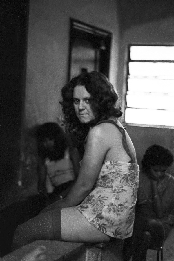 A woman sitting on top of a table in a room.