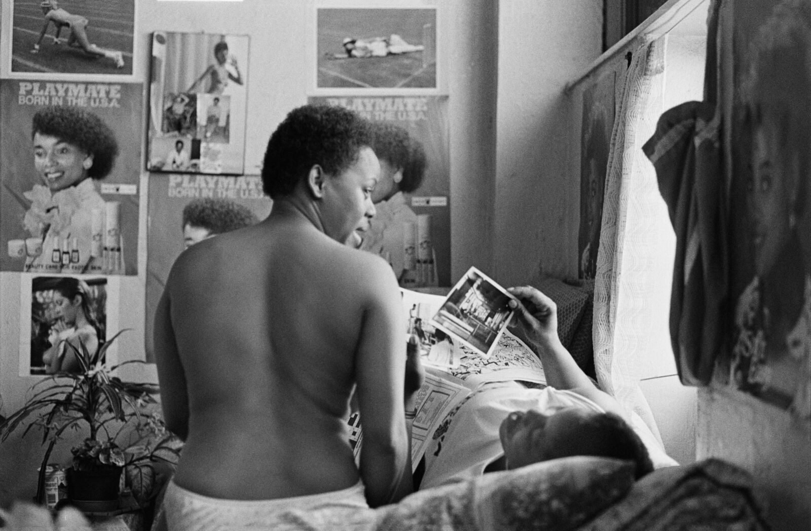 Woman sitting on her bed with a friend
