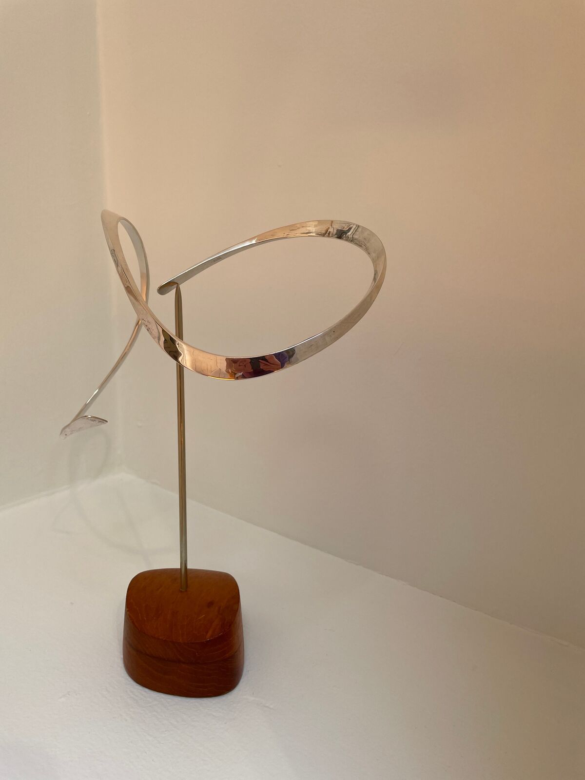 Artwork by Russell Secrest, Suspended Sculpture #3, Made of Sterling silver and wood 