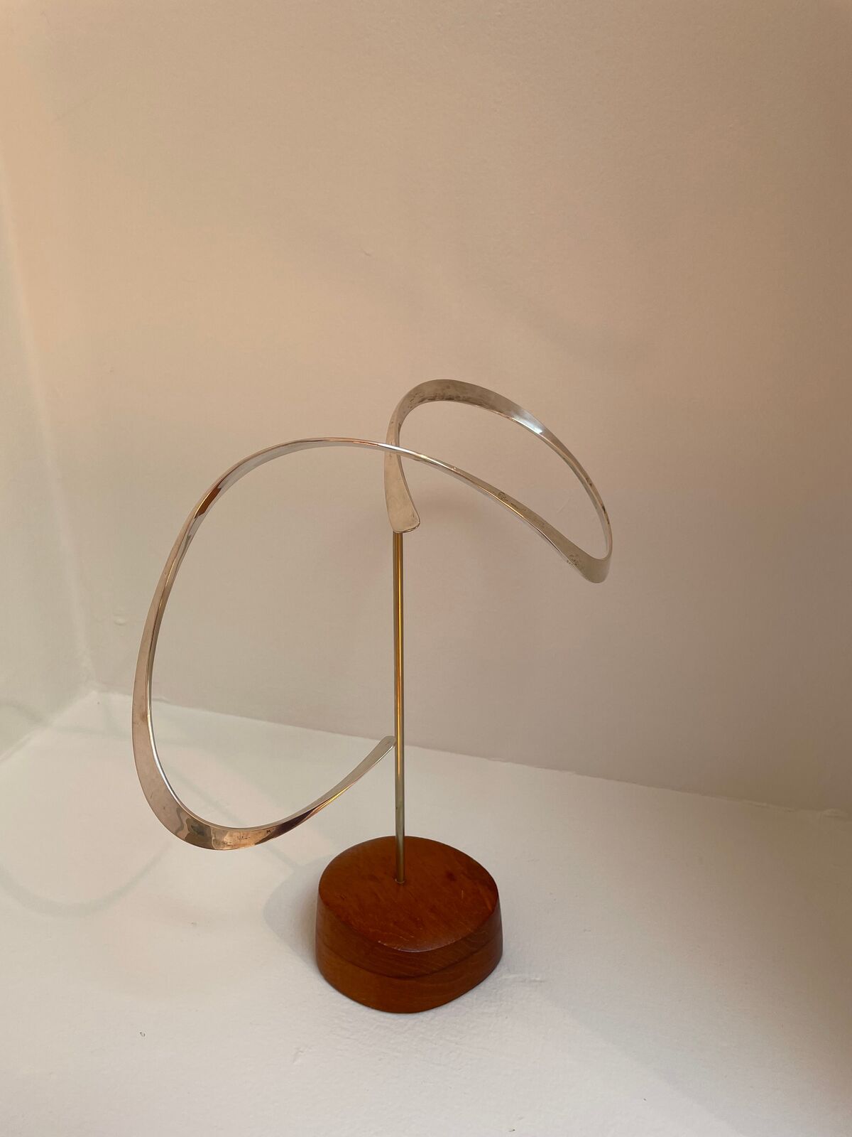 Artwork by Russell Secrest, Suspended Sculpture #3, Made of Sterling silver and wood 