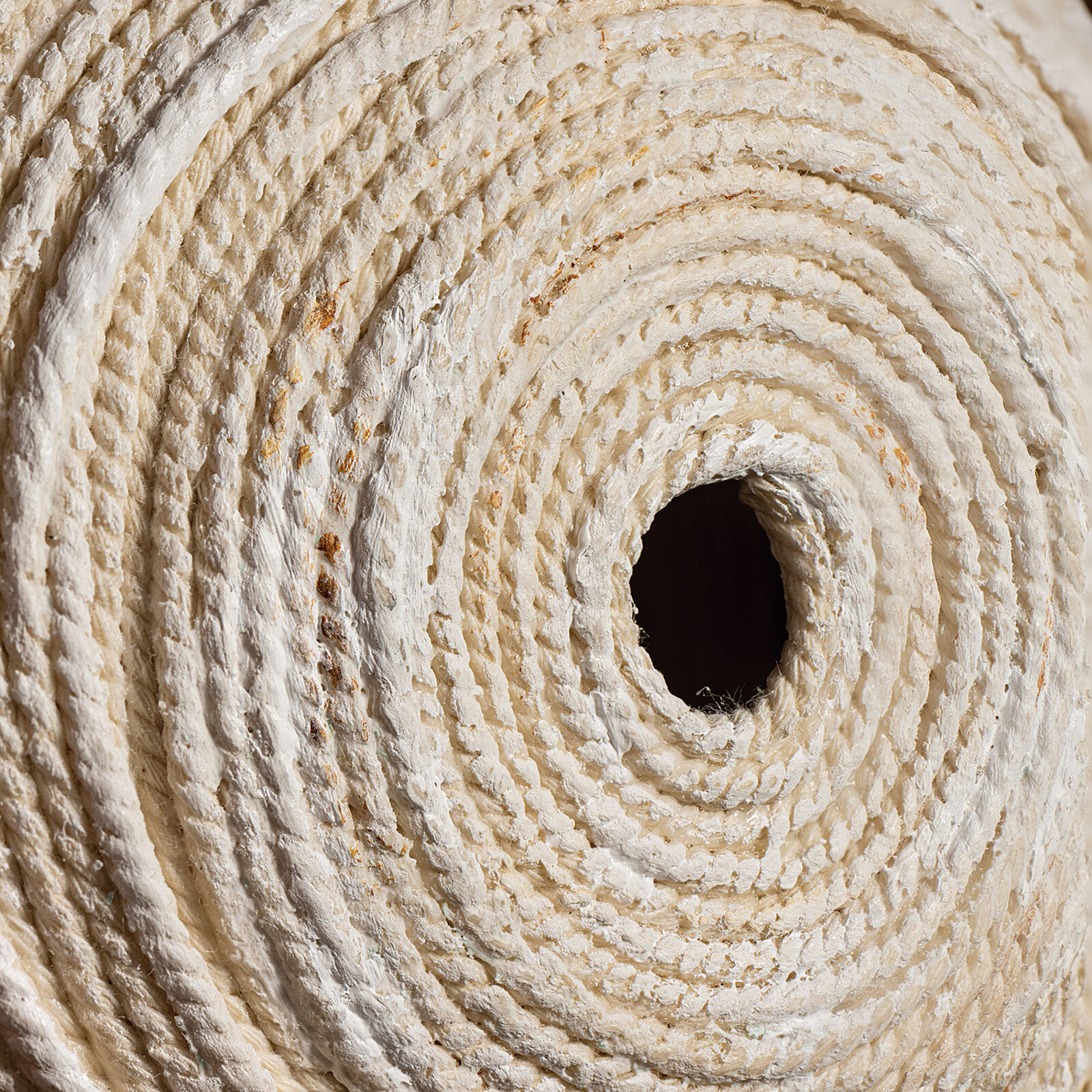 Two rolls of toilet paper sitting on top of a wooden shelf.