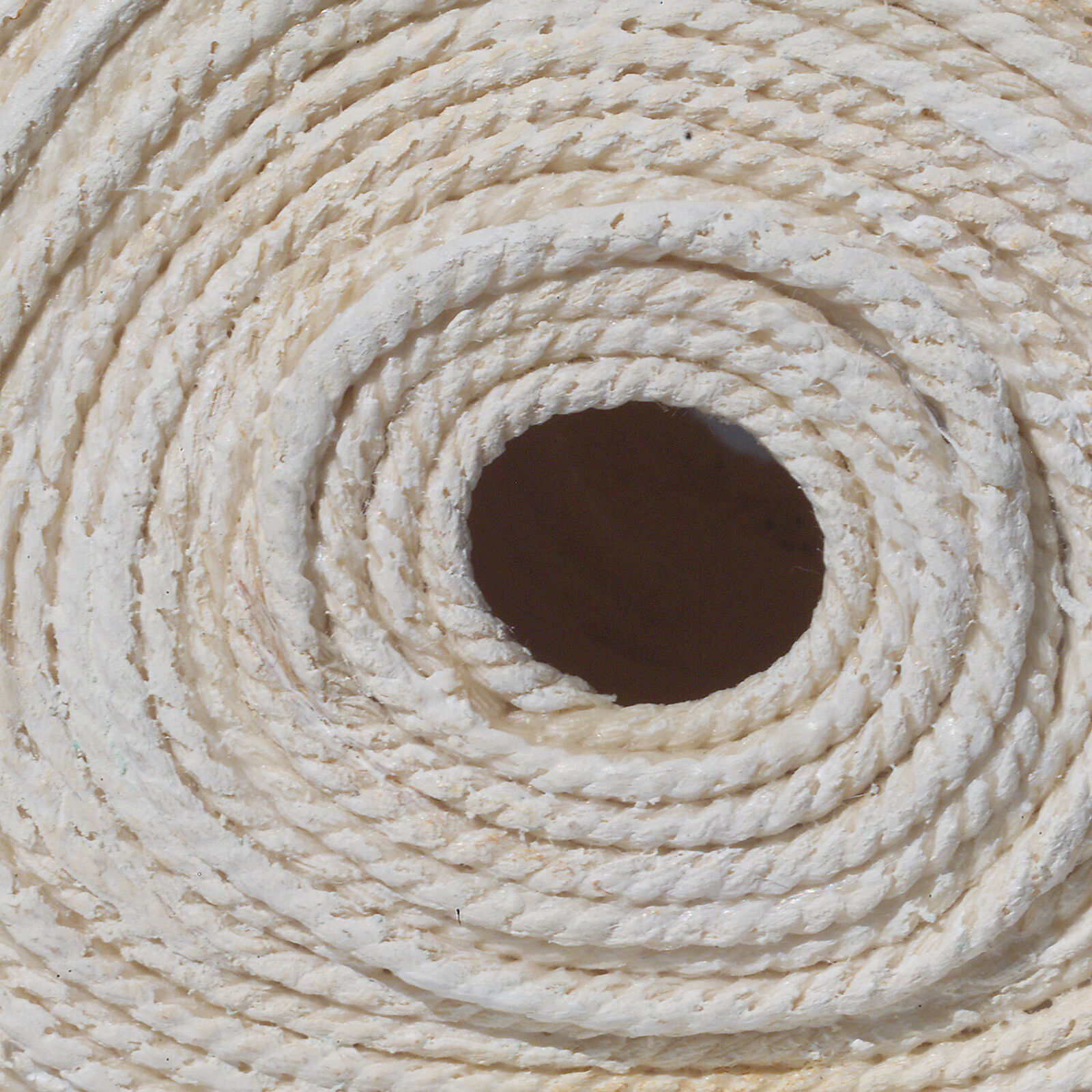 Two rolls of toilet paper sitting on top of a wooden shelf.