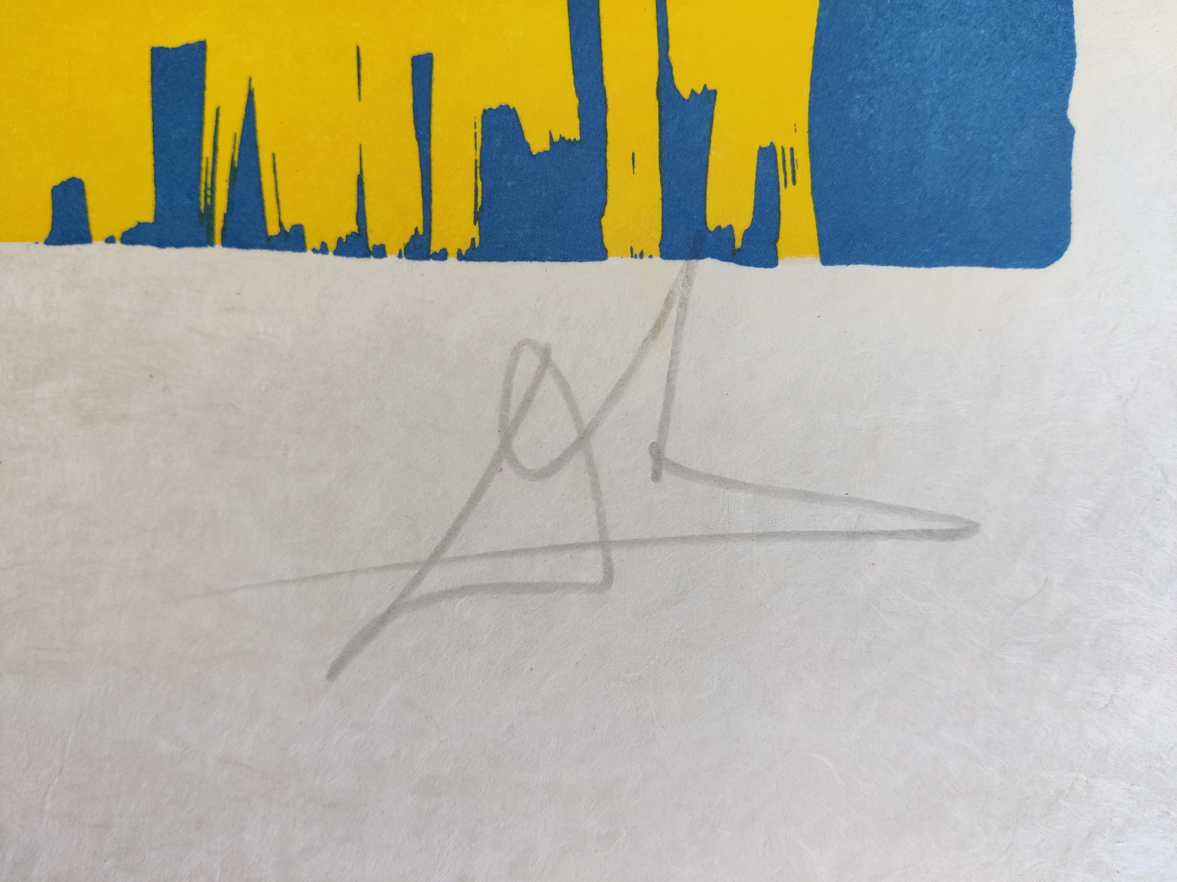 A blue and yellow print with an angel flying over a bed.