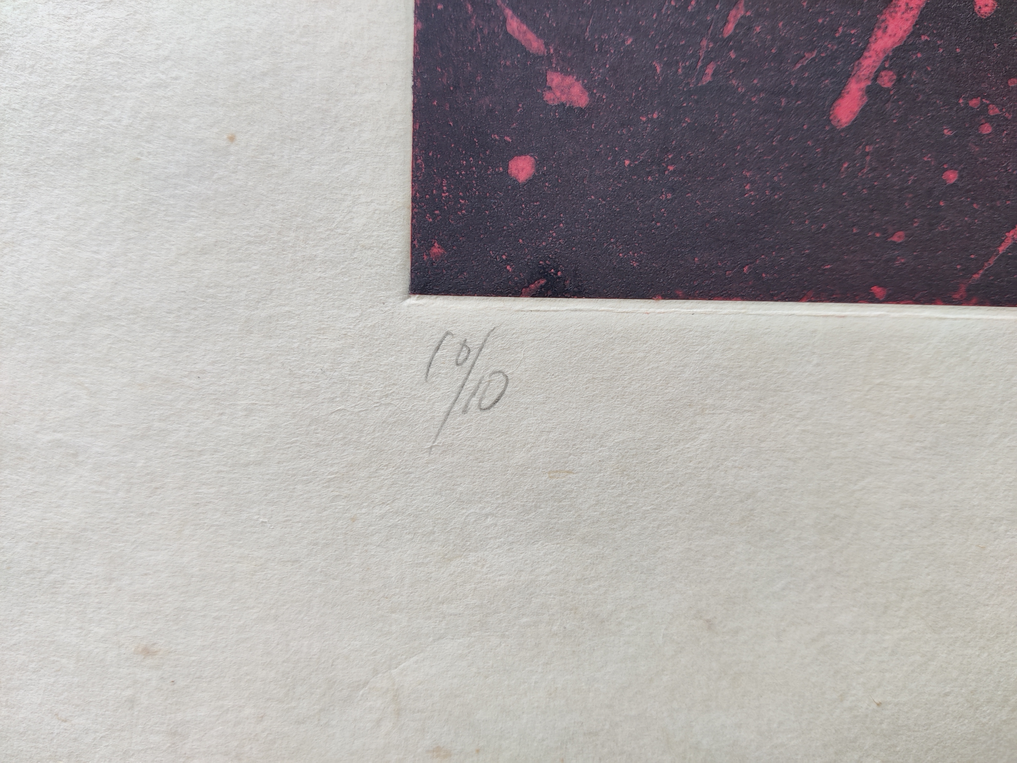 A red and black print on a piece of paper.