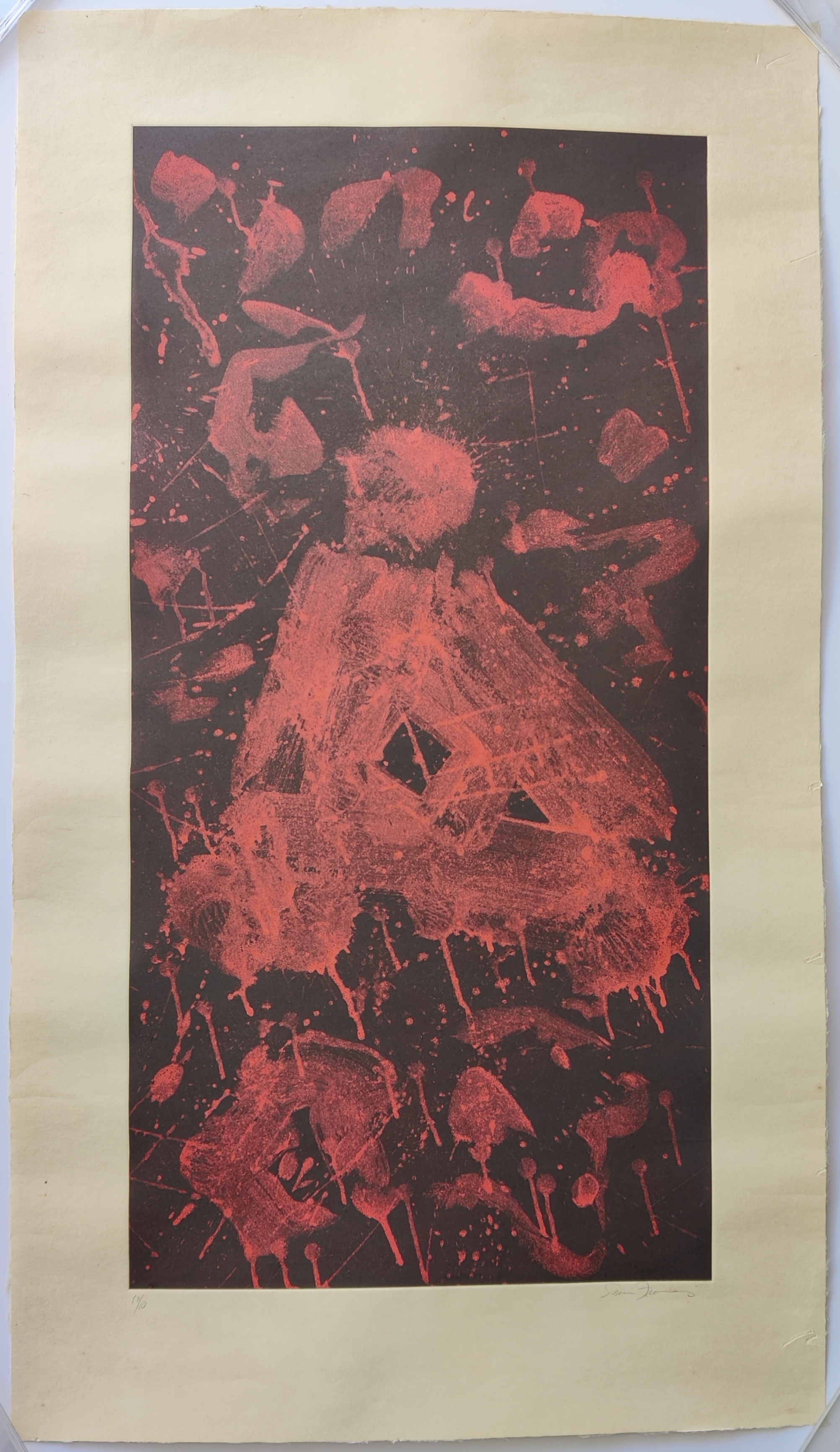 A red and black print on a piece of paper.