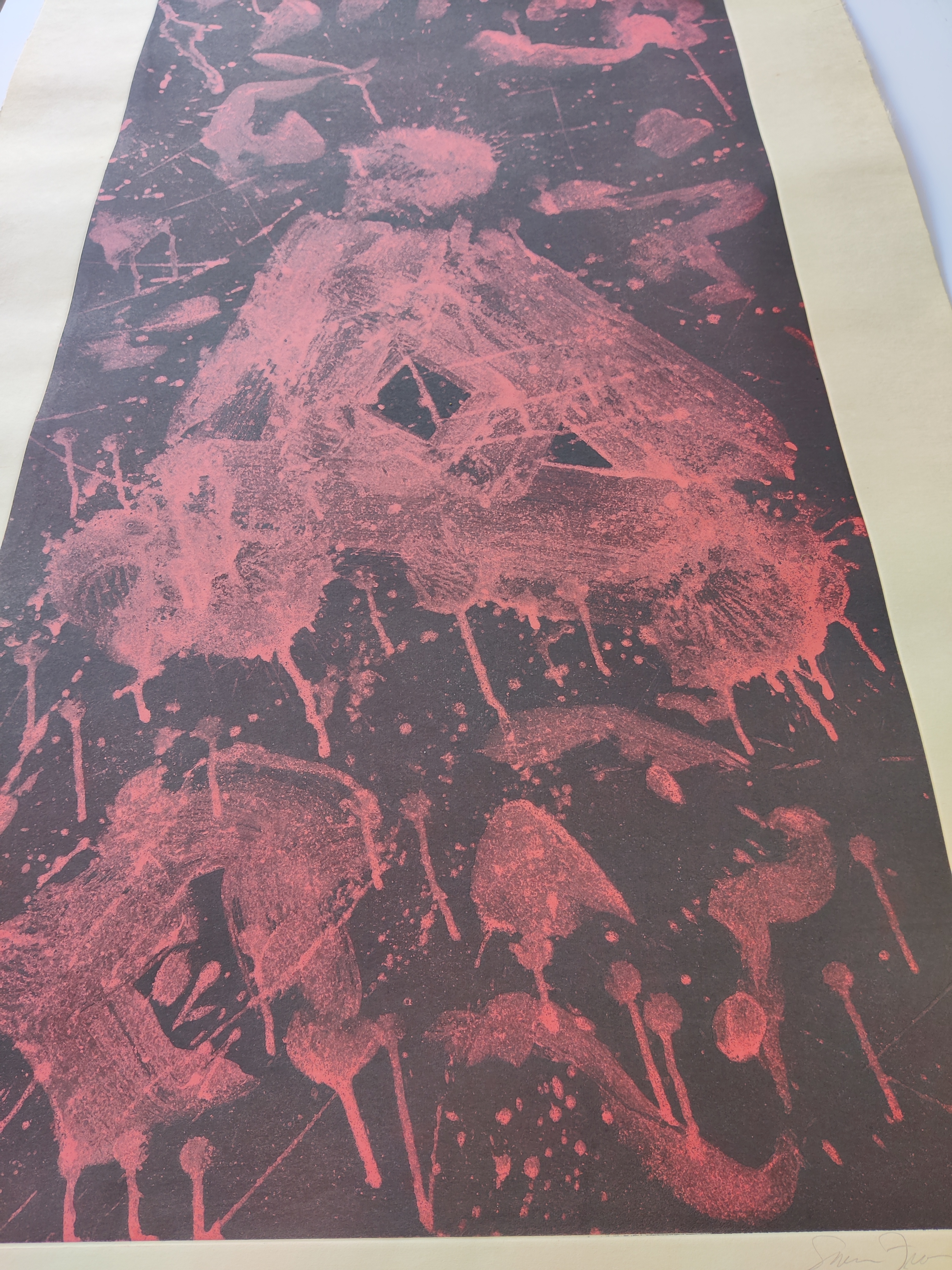 A red and black print on a piece of paper.