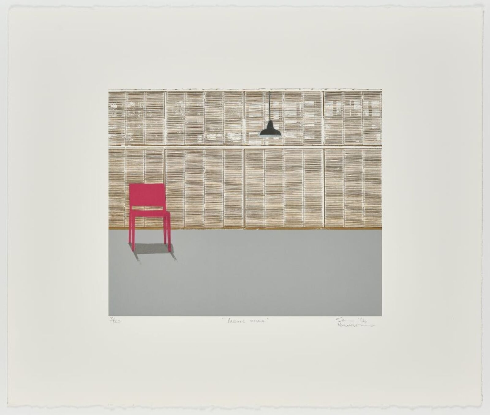 a red chair sitting in front of a wall