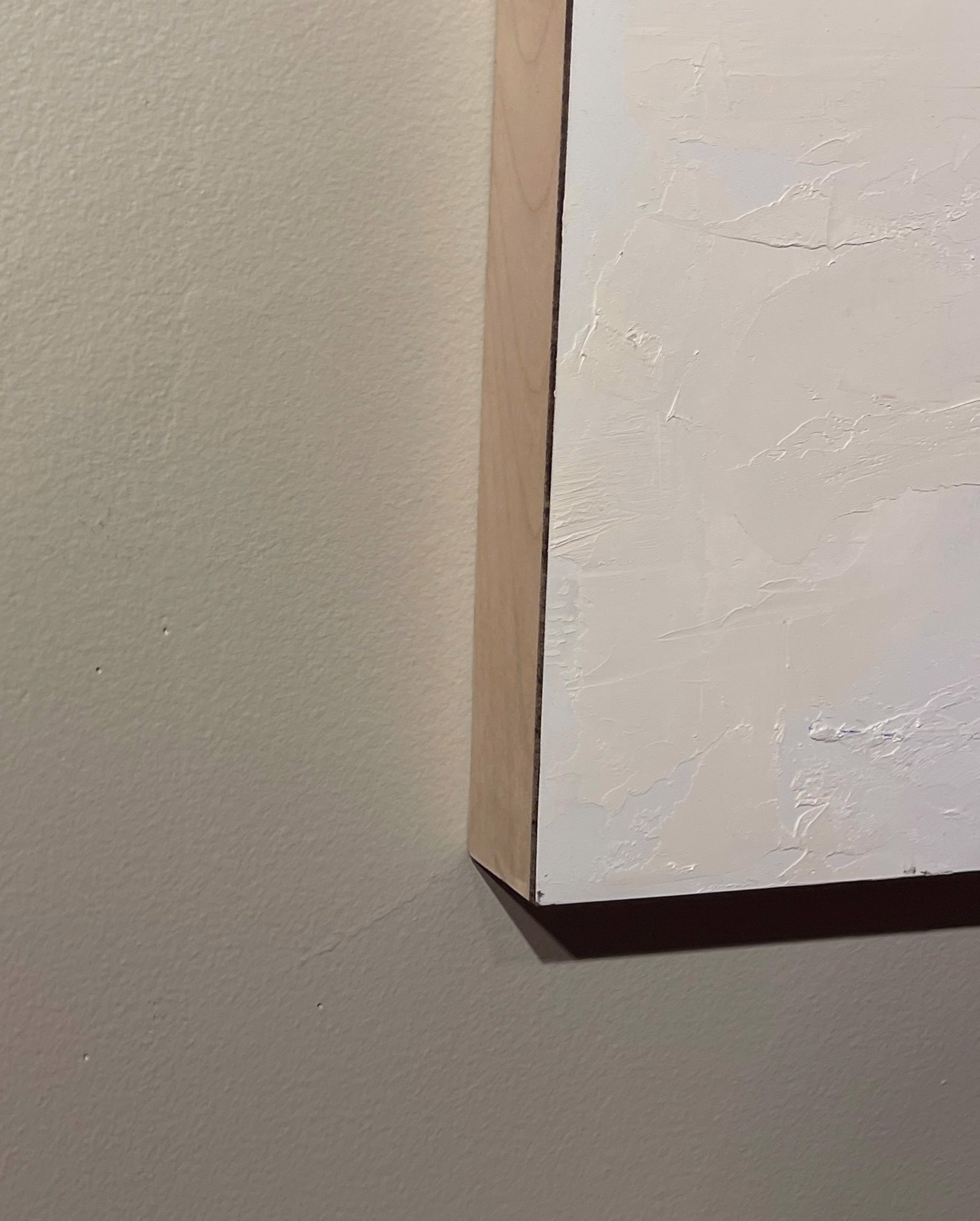 A painting of a red barn in the middle of a snowy field.