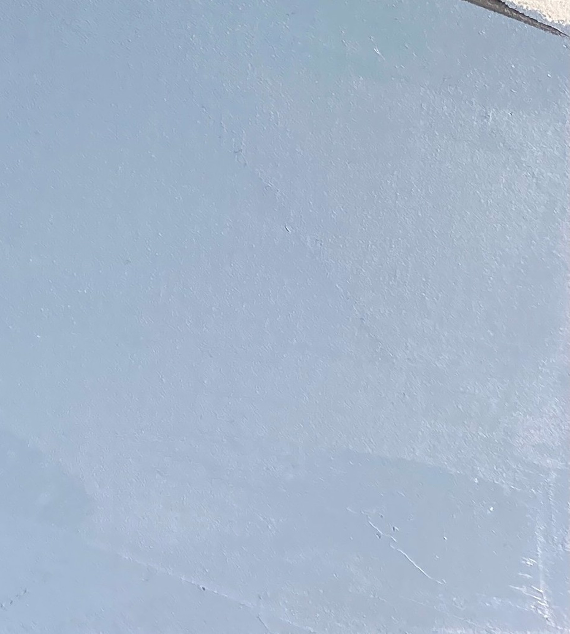 A painting of a street with houses in the background.