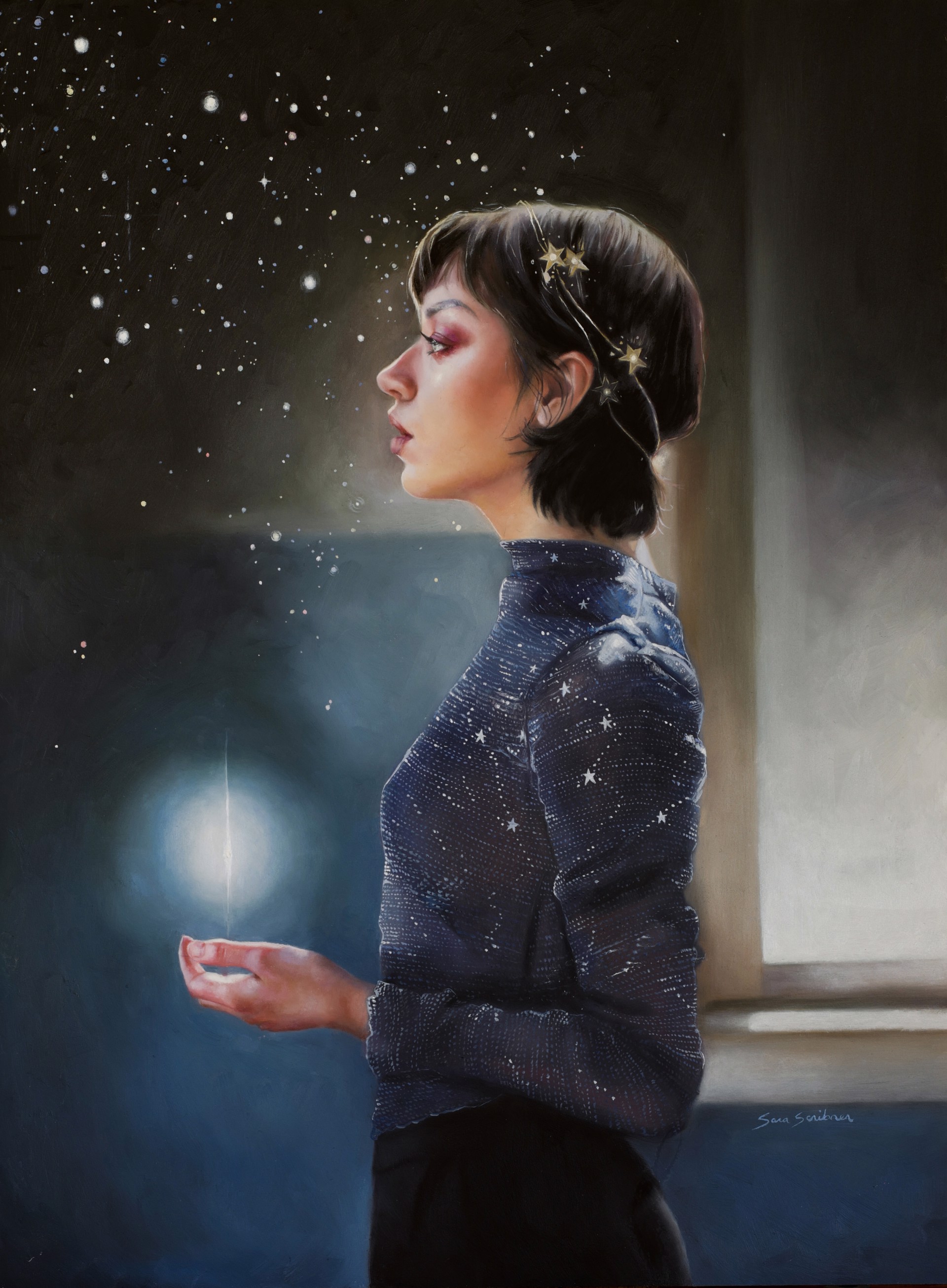 A person in a starry blue shirt stands by a window, holding a glowing orb while looking at the night sky.
