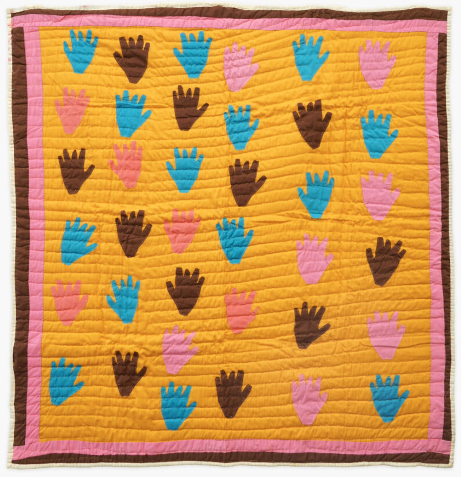 A quilted wall hanging with colorful handprints on it.