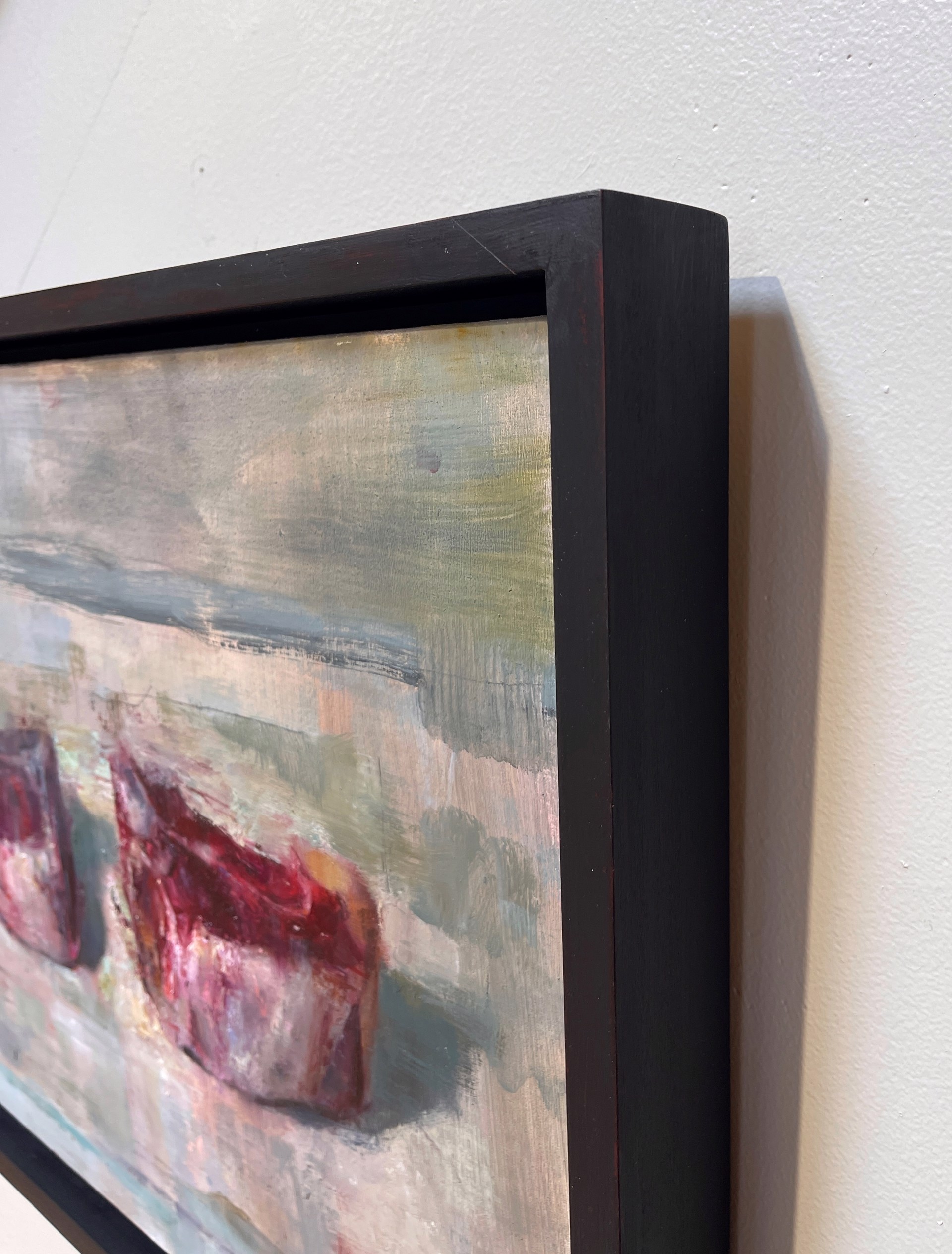 A painting of two red candles on a white surface.