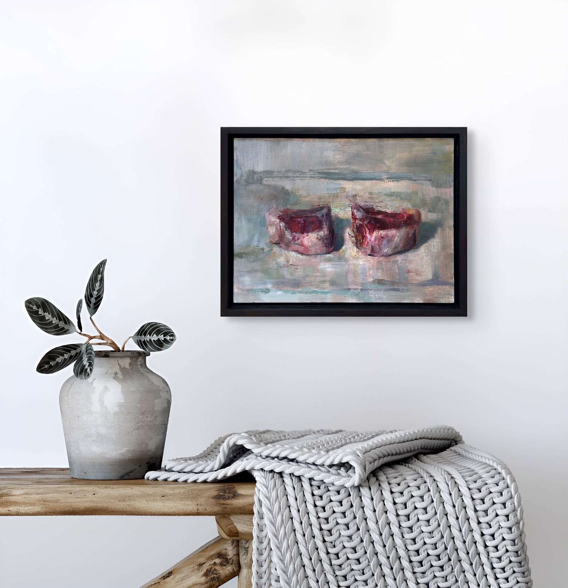 A painting of two red candles on a white surface.