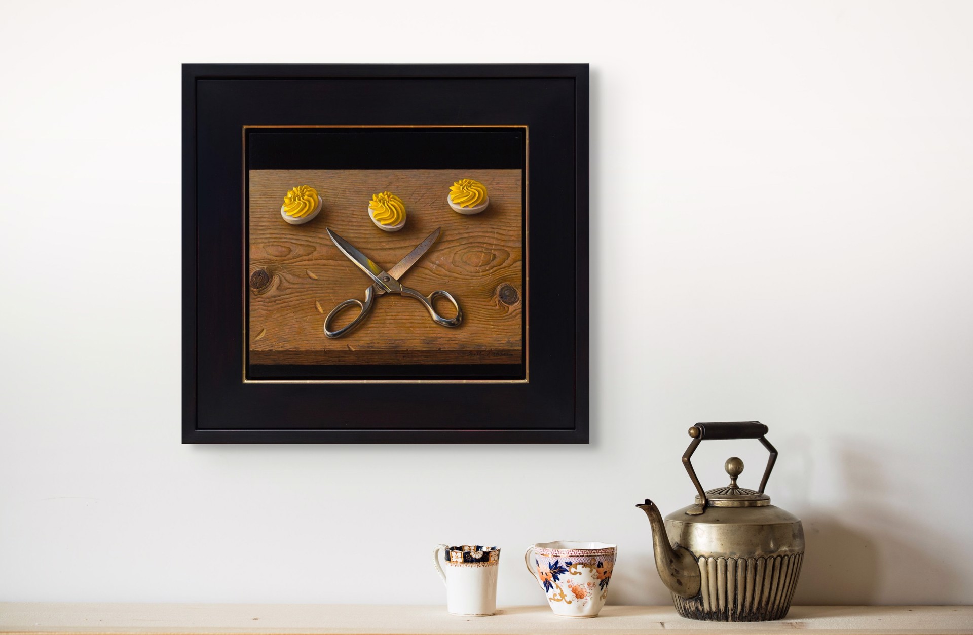 A still life painting featuring crossed silver scissors and three white discs topped with yellow frosting on a wooden surface.