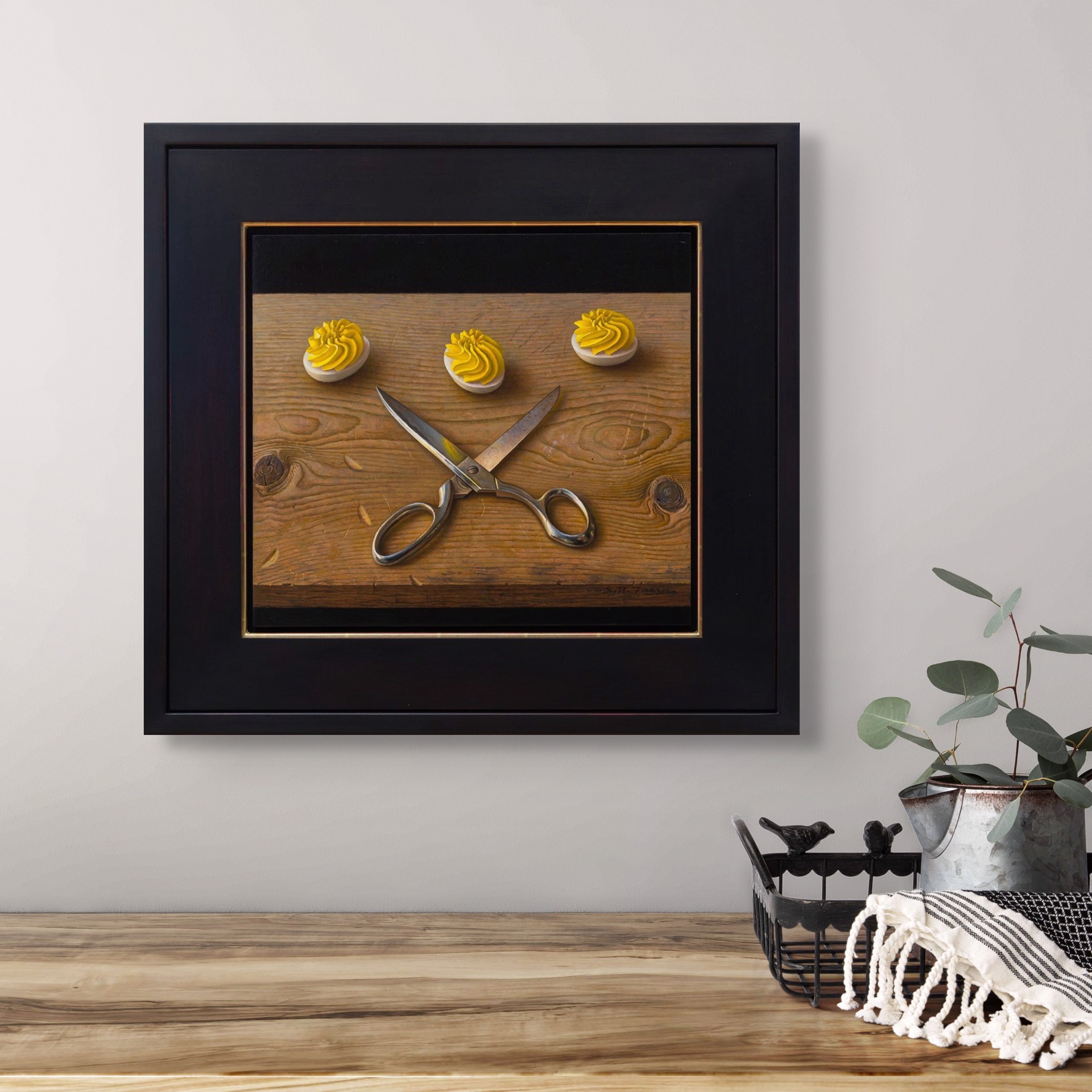 A still life painting featuring crossed silver scissors and three white discs topped with yellow frosting on a wooden surface.