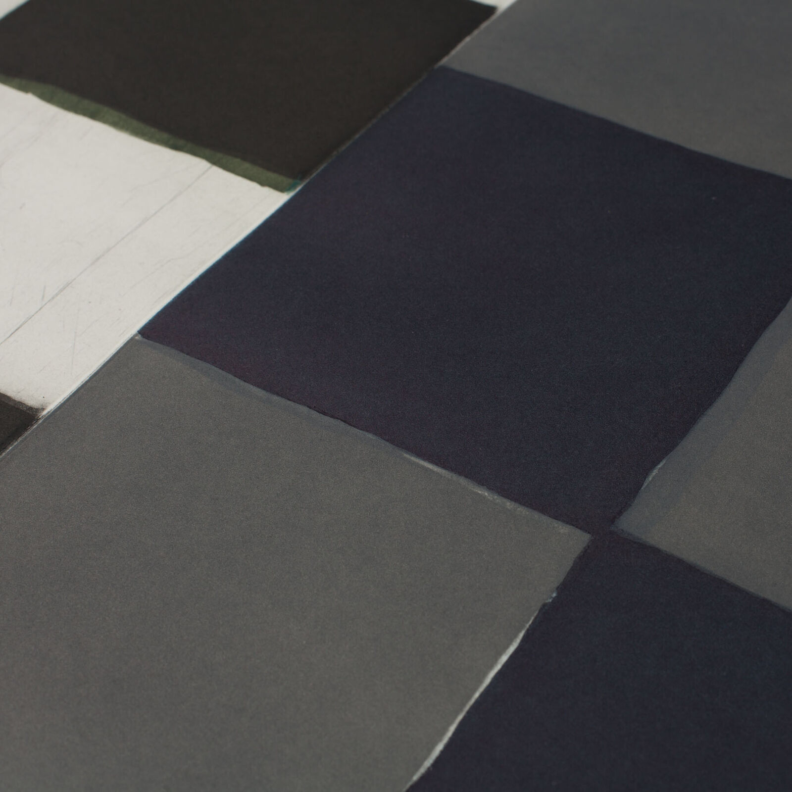 A black and white painting hanging on a wall.